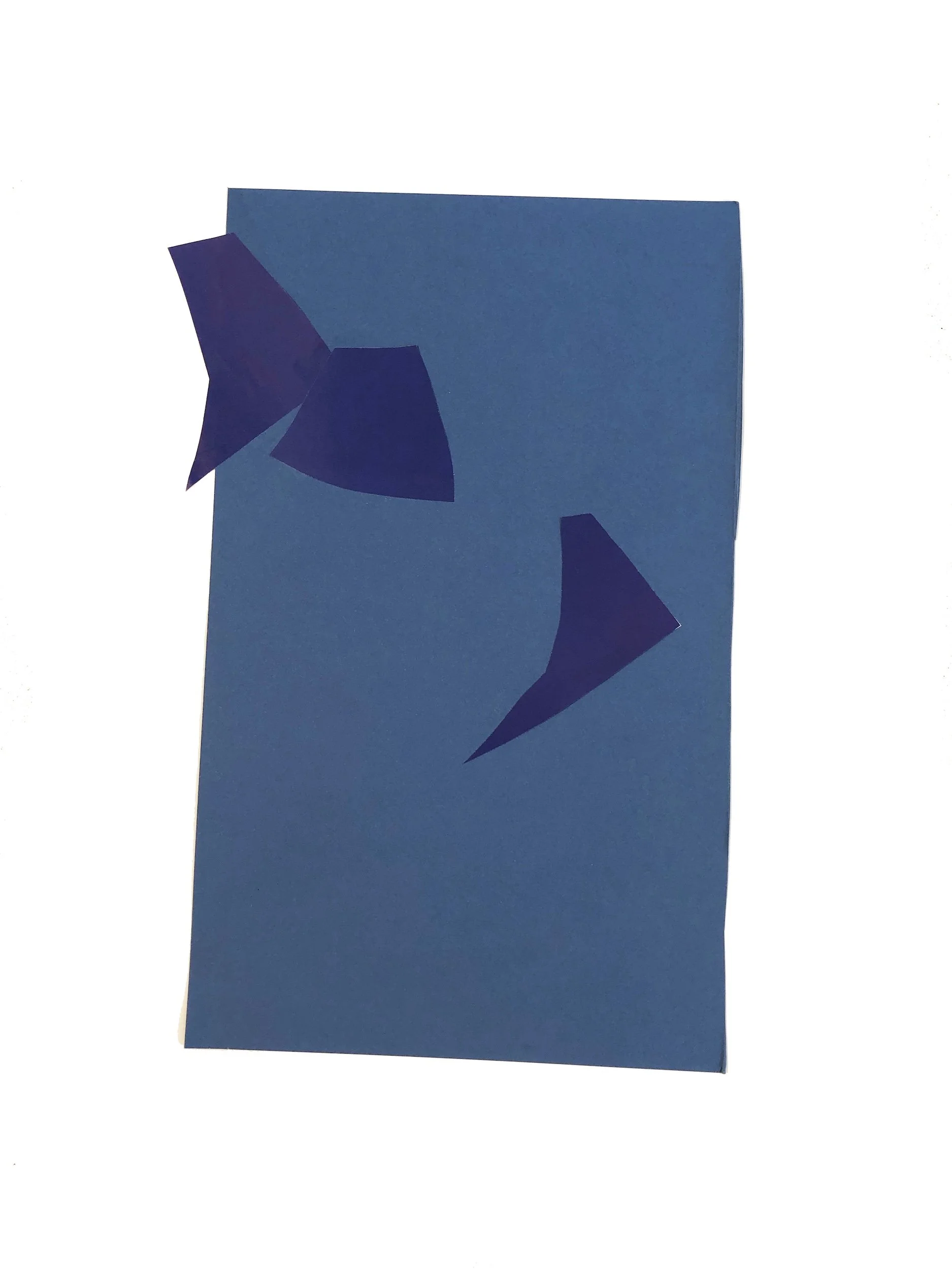 Blue greeting card with dark blue paper cutouts resembling birds or butterflies attached to the front.