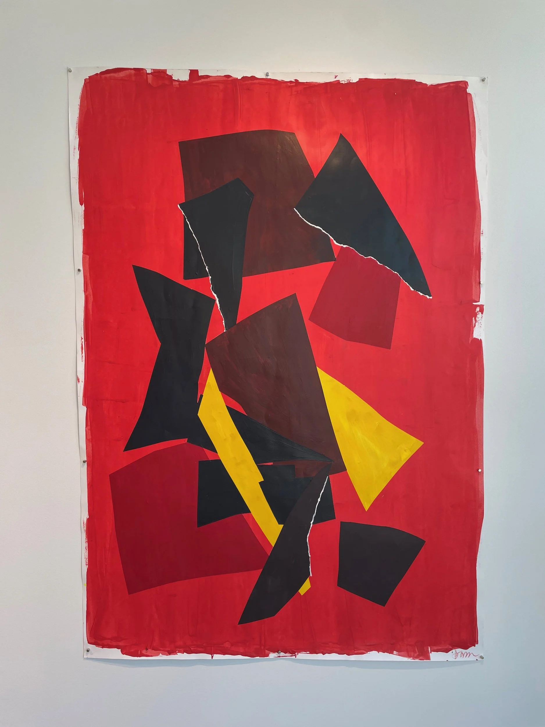 Abstract collage art with torn paper shapes in black, red, yellow, and brown on a red background.