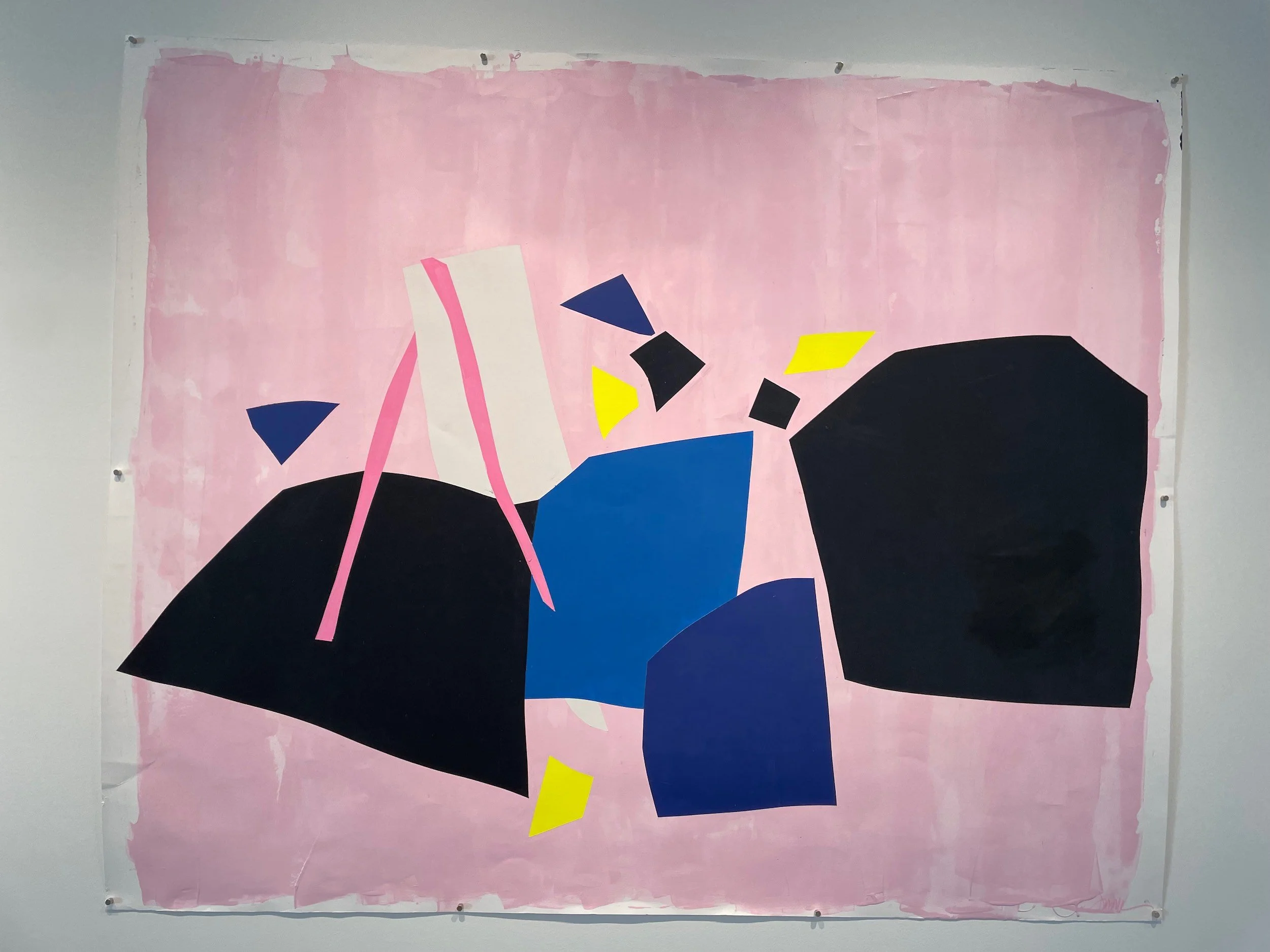 Abstract geometric mural with black, blue, pink, yellow, and white shapes on a pink background