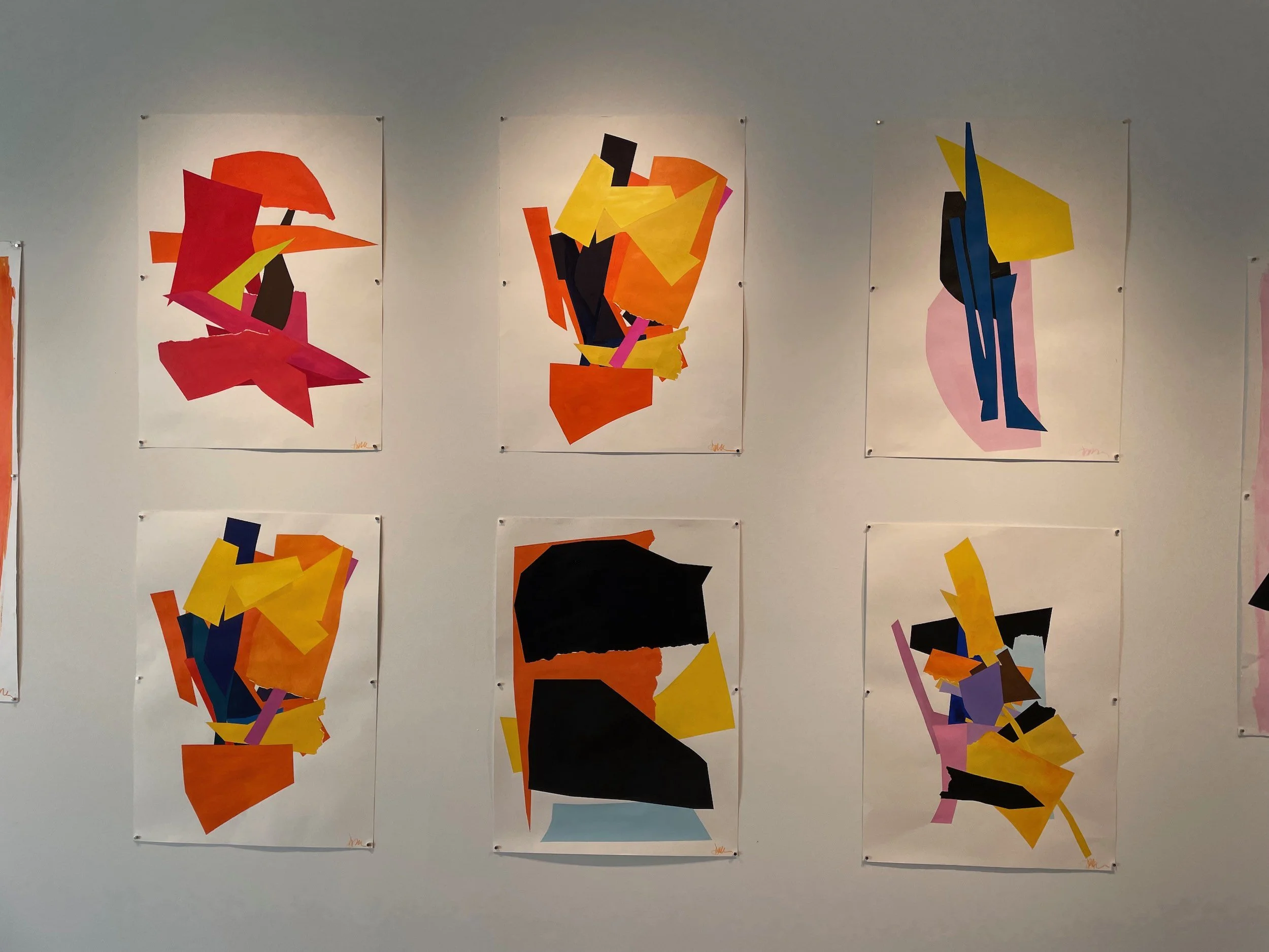 Six abstract colorful paintings arranged in two rows on a gallery wall.
