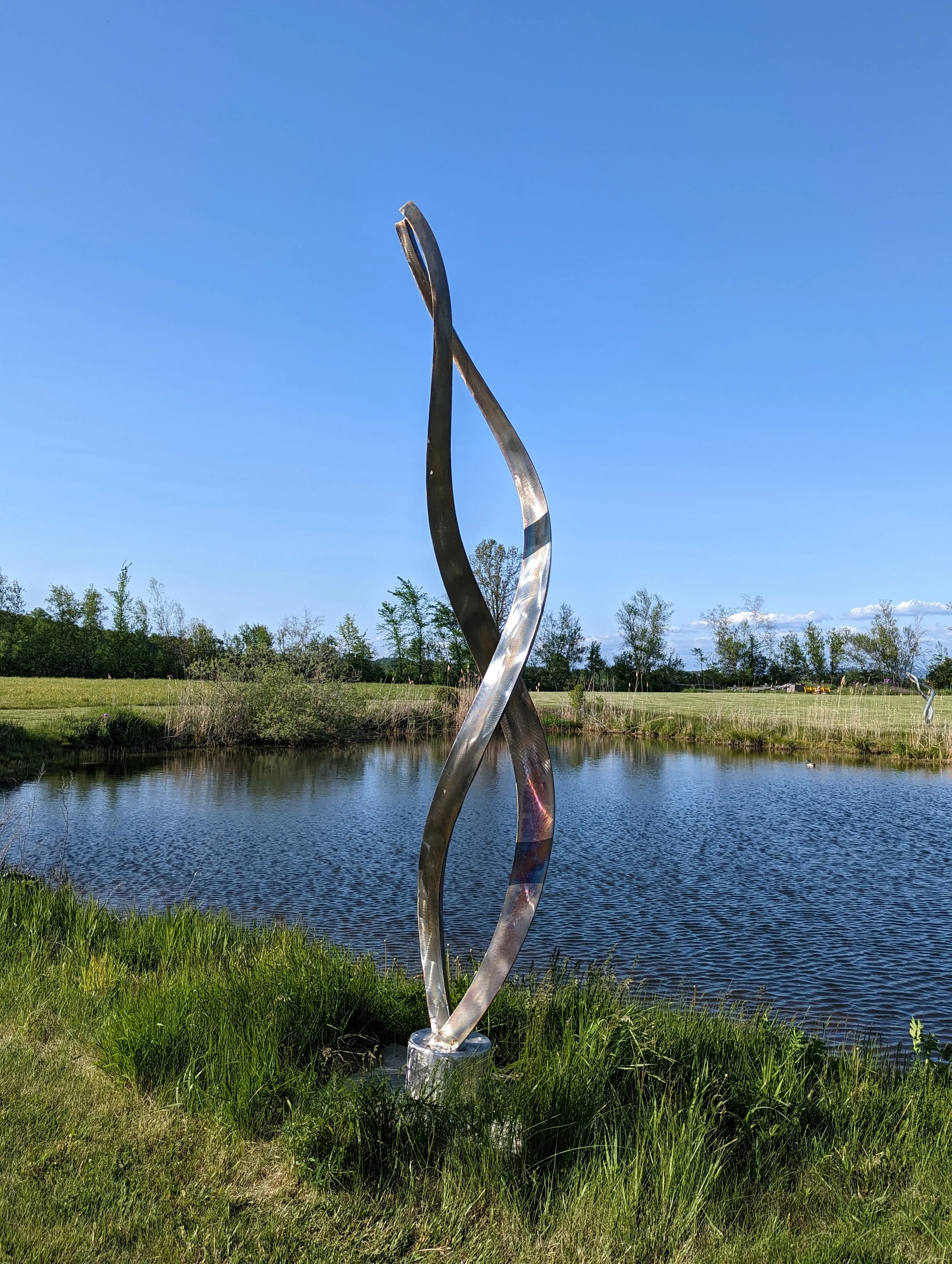 36. " Ancestral DNAIII" Stainless steel 140" x 22" Diameter. The sculpture rotates on a bearing. $25,000