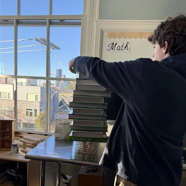 Why are triangles the strongest shape?
10th-grade geometry students explored the answer by designing and engineering structures meant to hold the weight of textbooks.

The lesson moved from theory to practice as students tested ideas, adjusted design