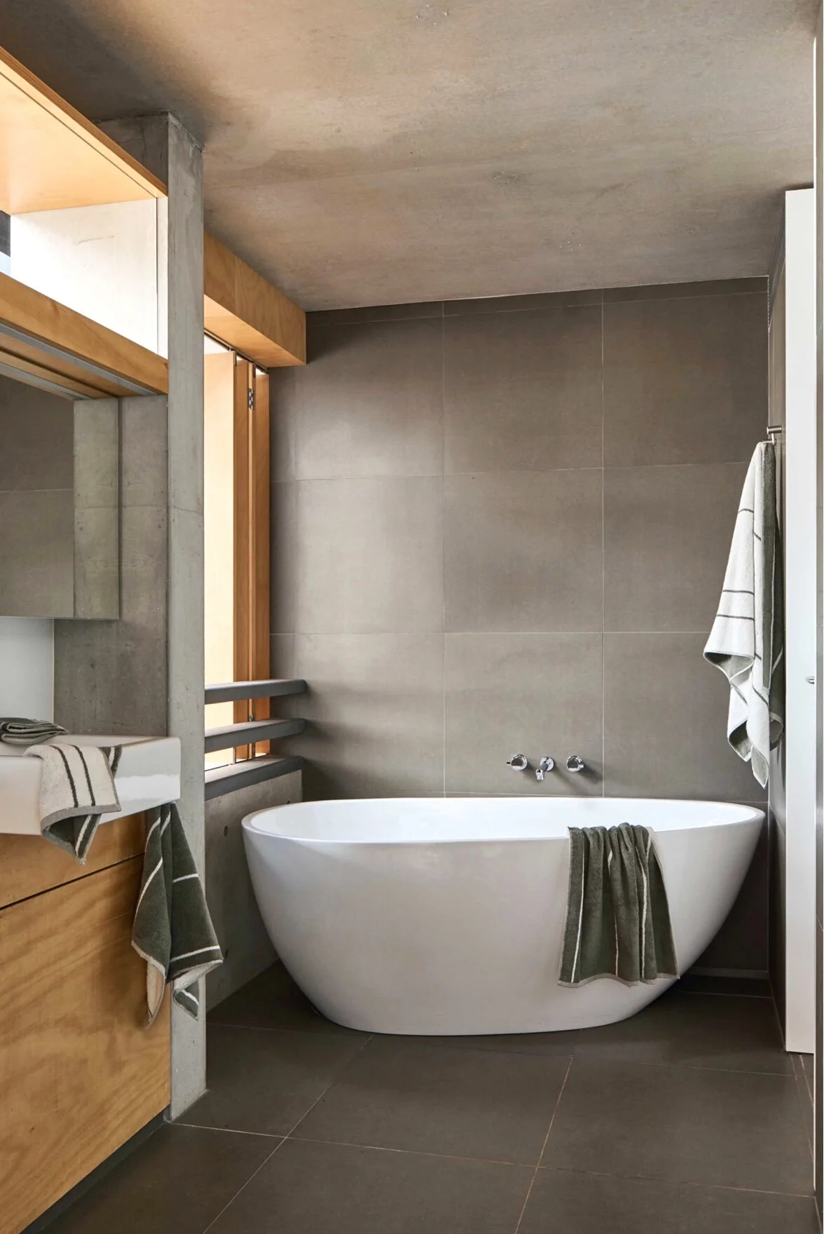 In the bathroom is a selection of IN BED organic cotton towels in khaki stripe.