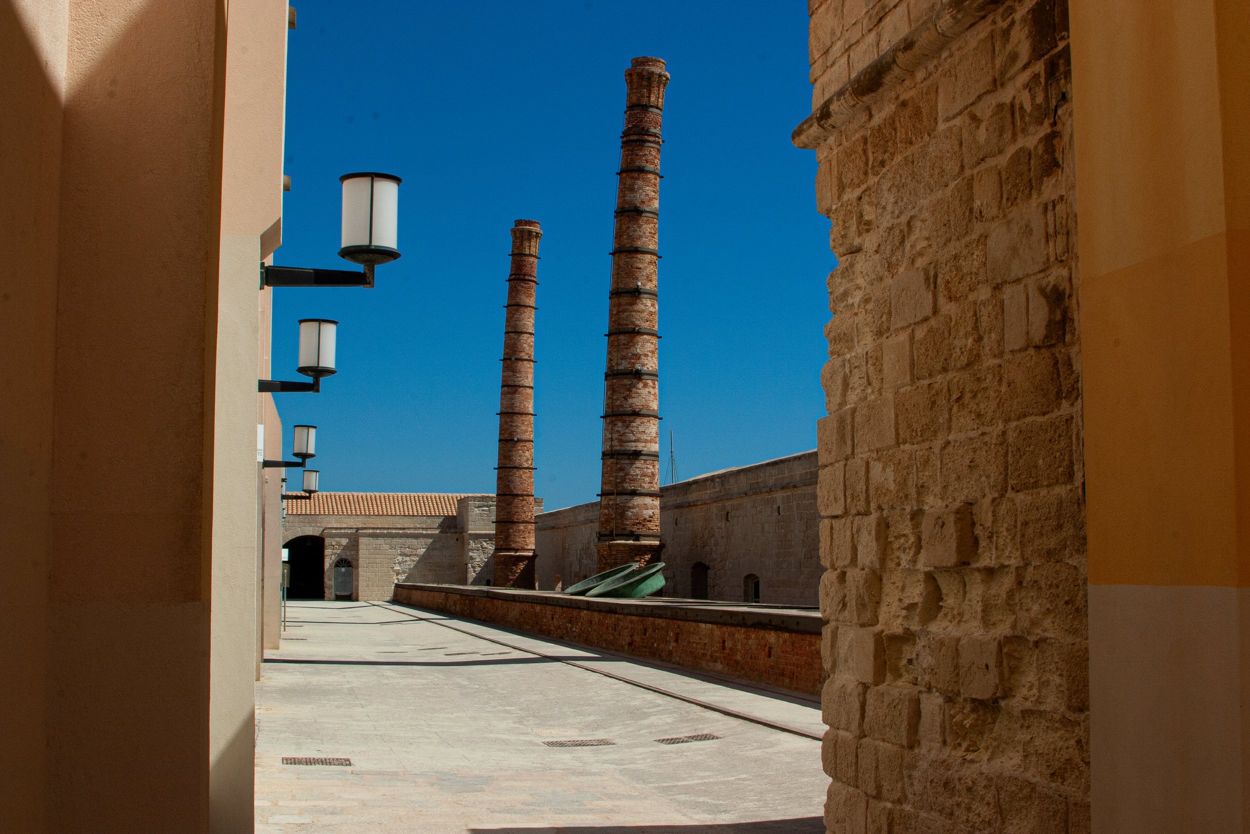  Figure 31. A view of one of the internal courtyards. This area once had a roof and was where workers cooked the tuna in large vats before canning them. The chimneys were part of a larger mechanical system that conducted smoke and steam away from the