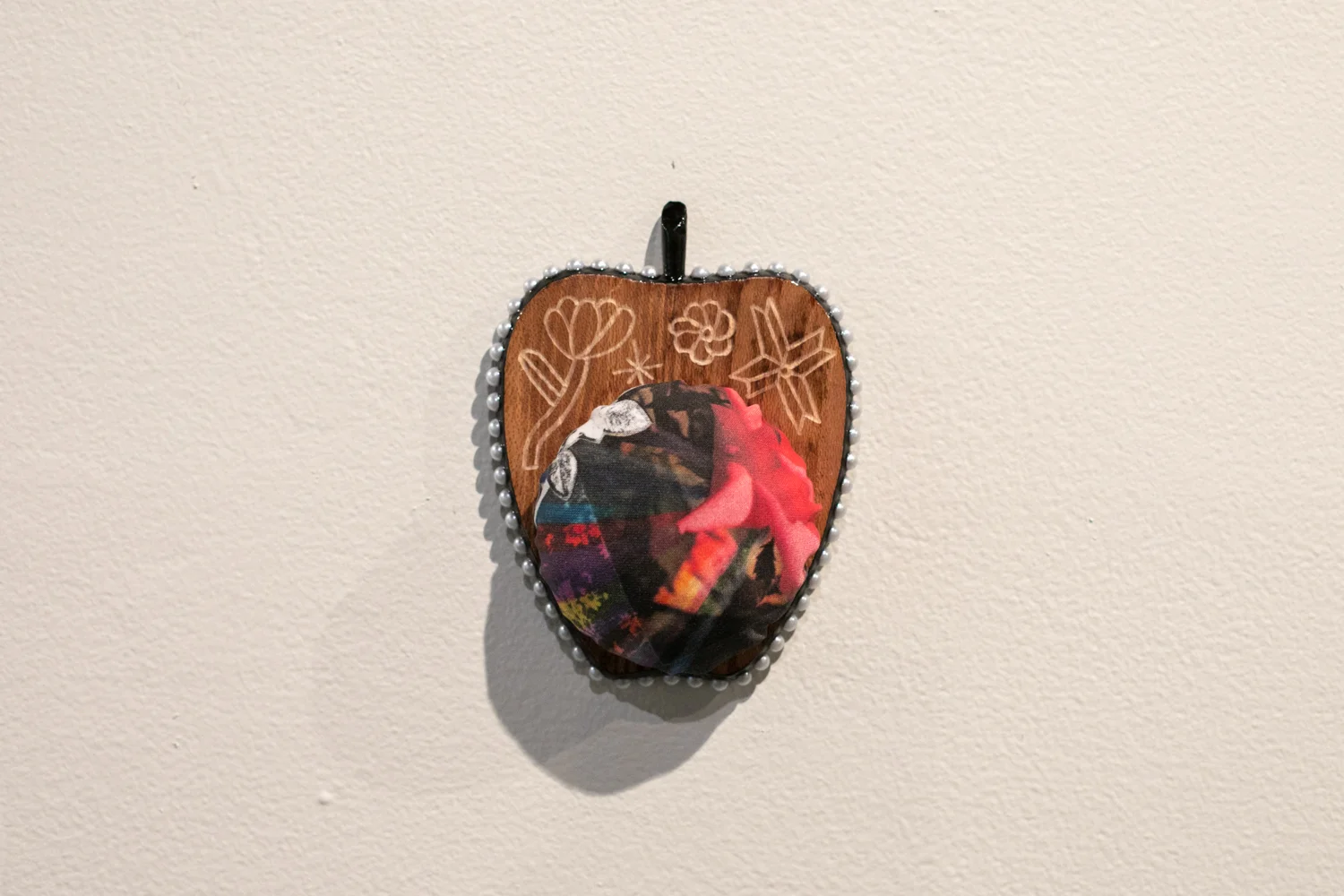 Apple Isle Pincushion, 2019, found wood coaster (engraved), handmade paper collage digitally printed on cotton sateen, plastic pearls, acrylic paint, resin. Photography by Mel De Ruyter