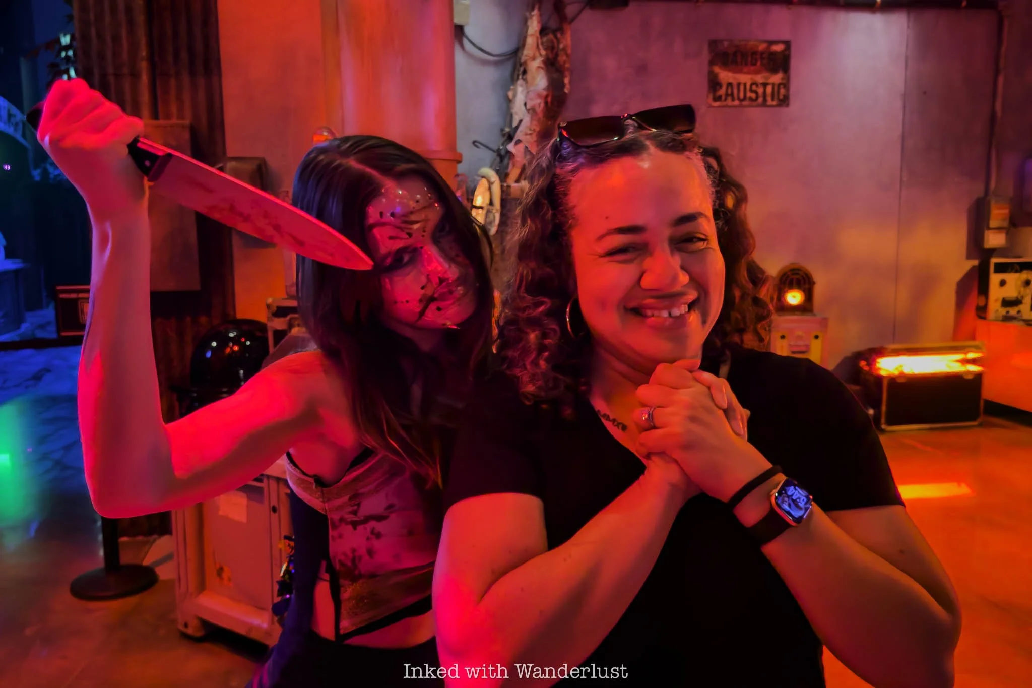 A person posing for a photo with a scare actor at Universal Horror Unleashed.