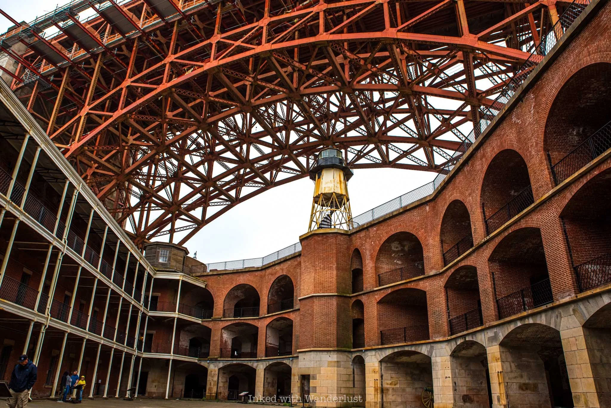 Inside the walls of Fort Point with the Golden Gate Bridge spanning overhead.