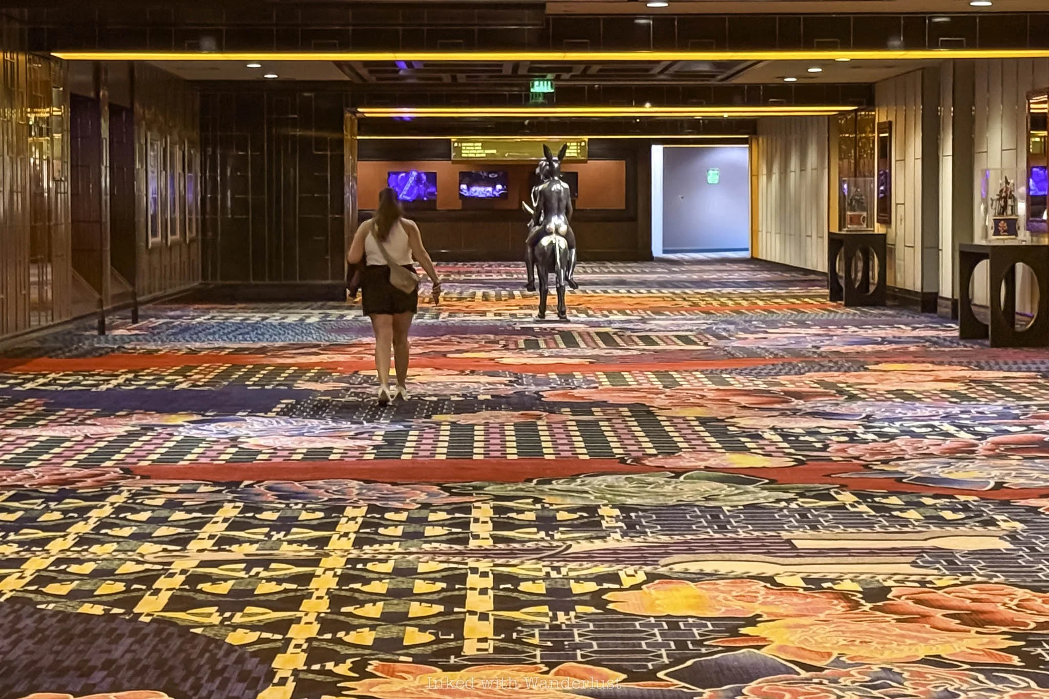A person walking down a long hallway at Cosmopolitan Las Vegas.