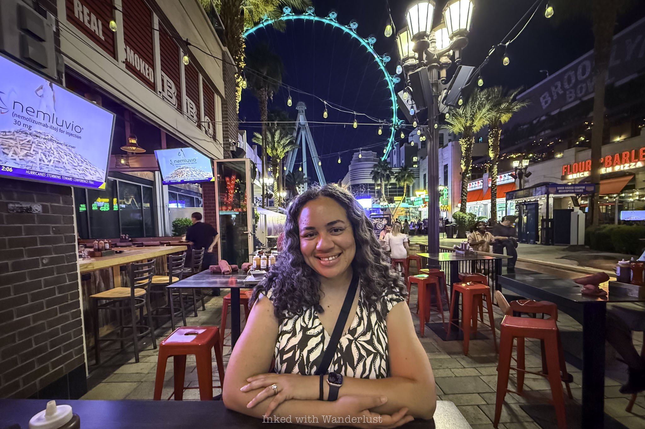 A person eating dinner with High Roller in the background.
