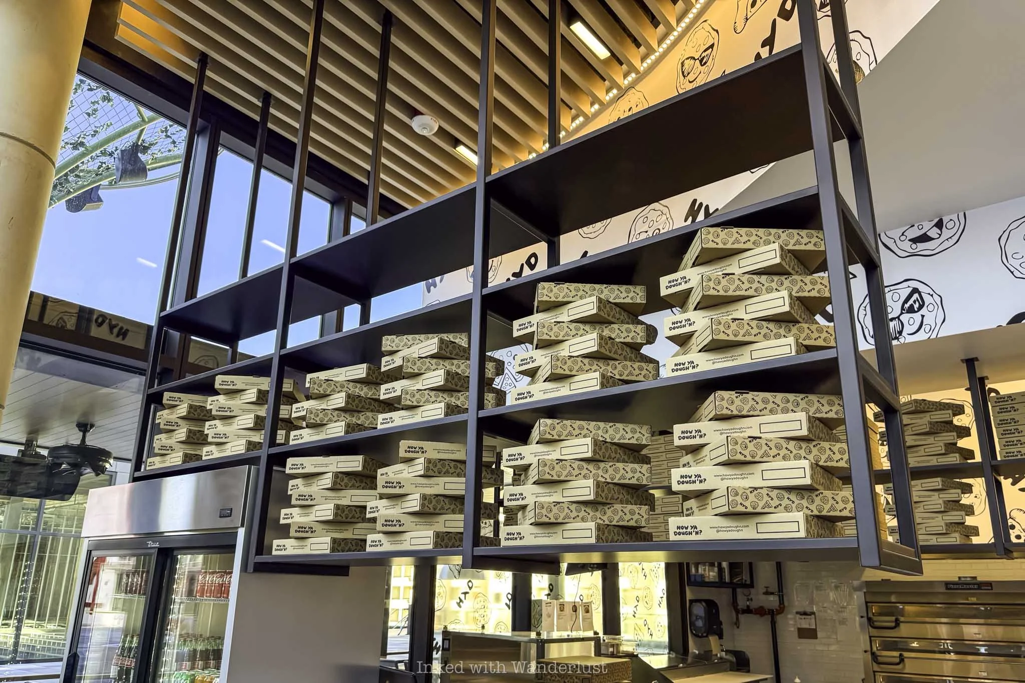 Pizza box display inside How Ya Dough'n Pizza in Las Vegas.