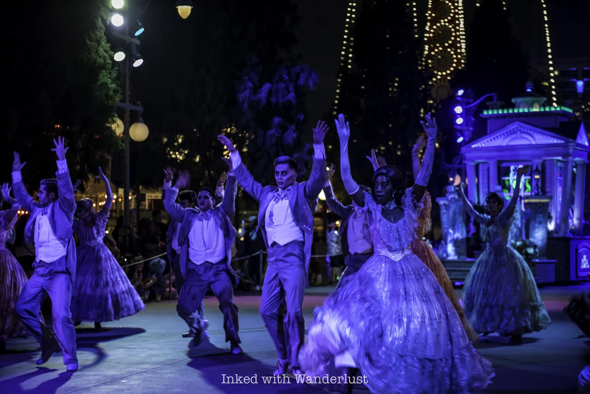 Parade performers with the Haunted Mansion float at Oogie Boogie Bash parade.