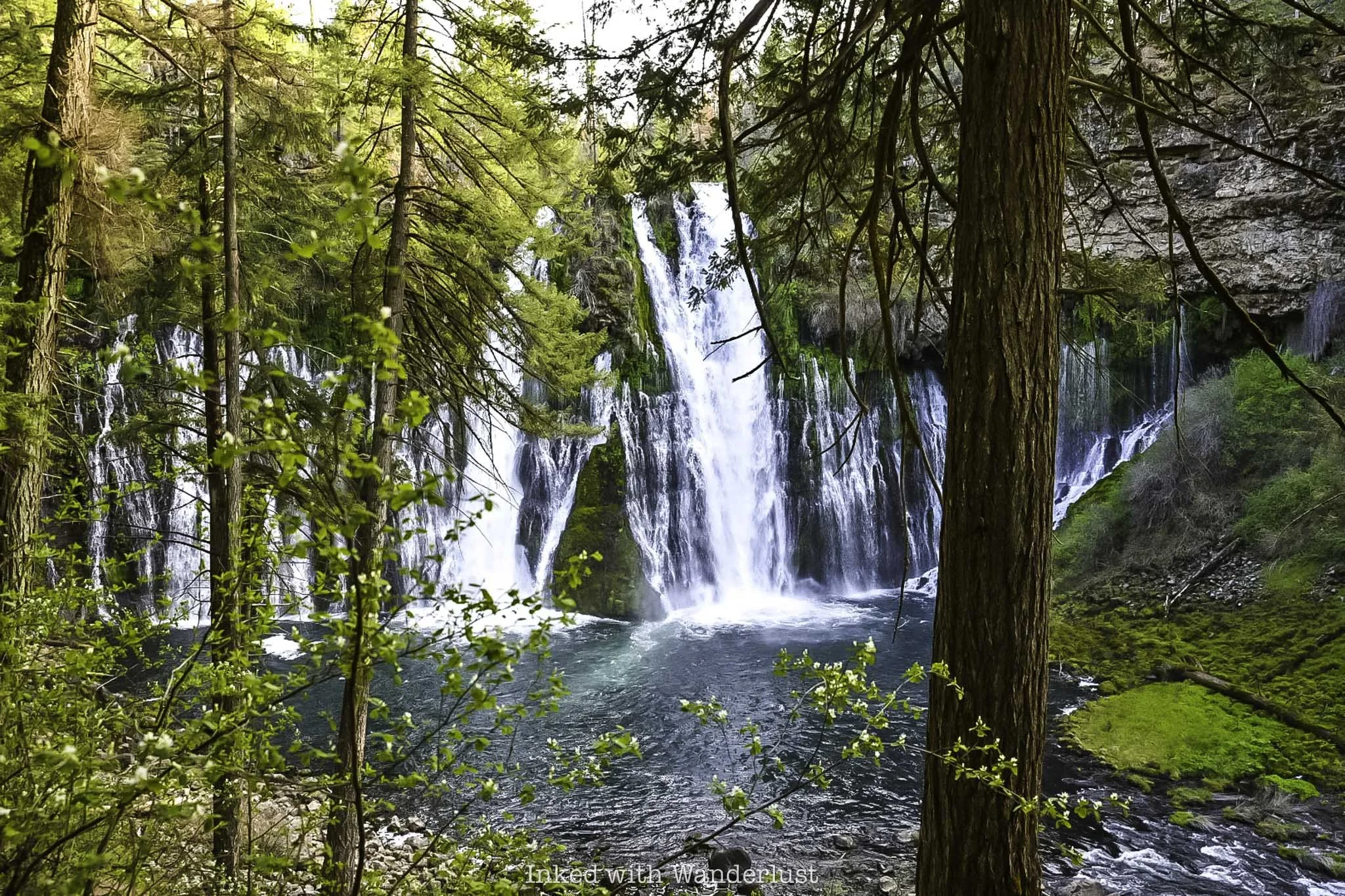 Burney Falls as viewed through trees.