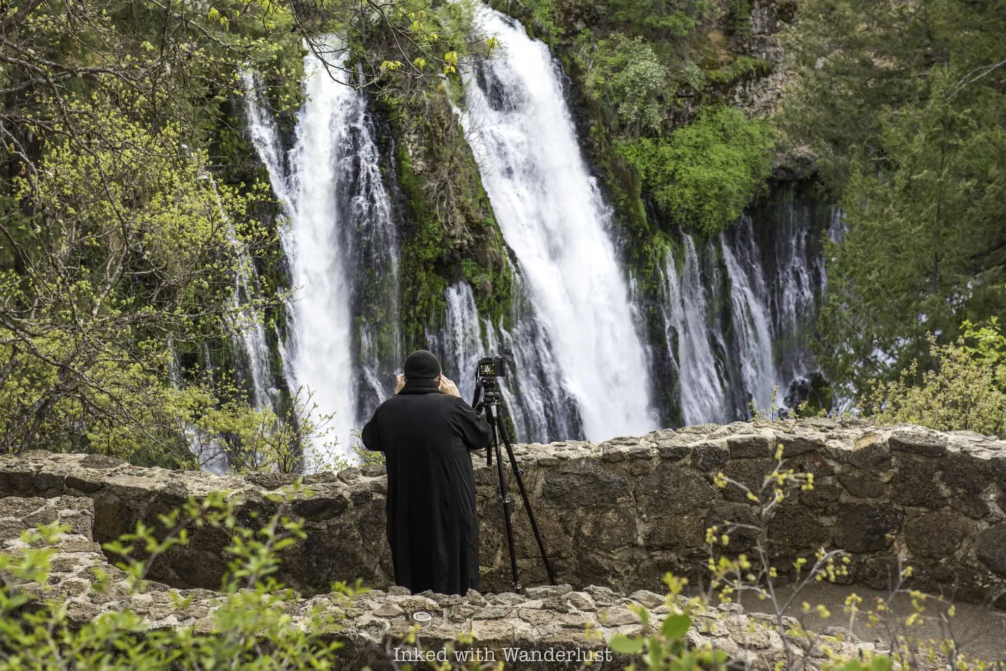 A photographer admiring Burney Falls from the upper viewing deck.
