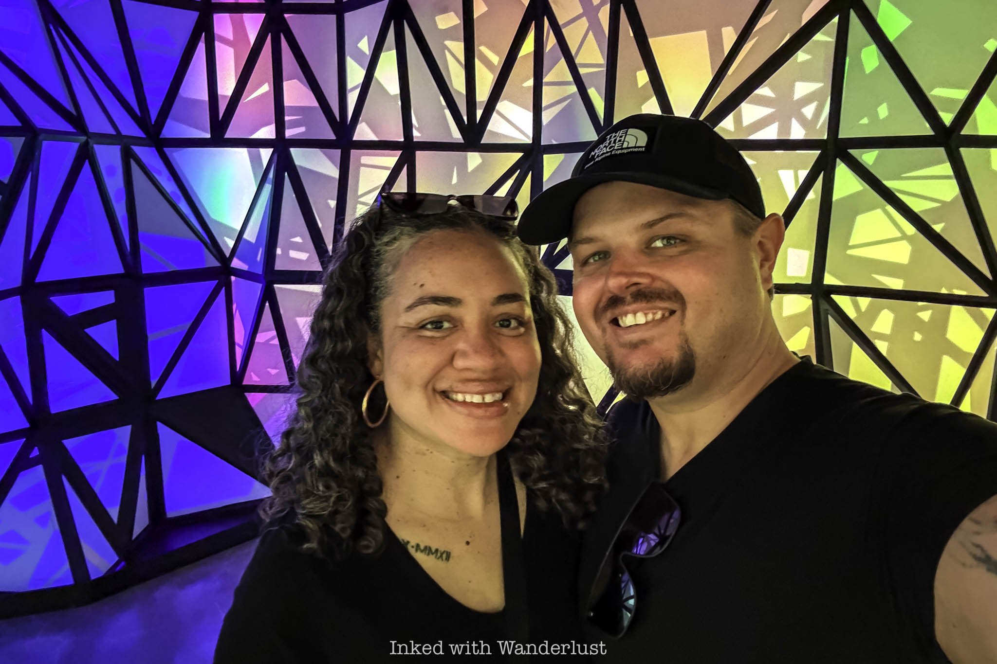 Two people taking a picture at Meow Wolf Omega Mart.