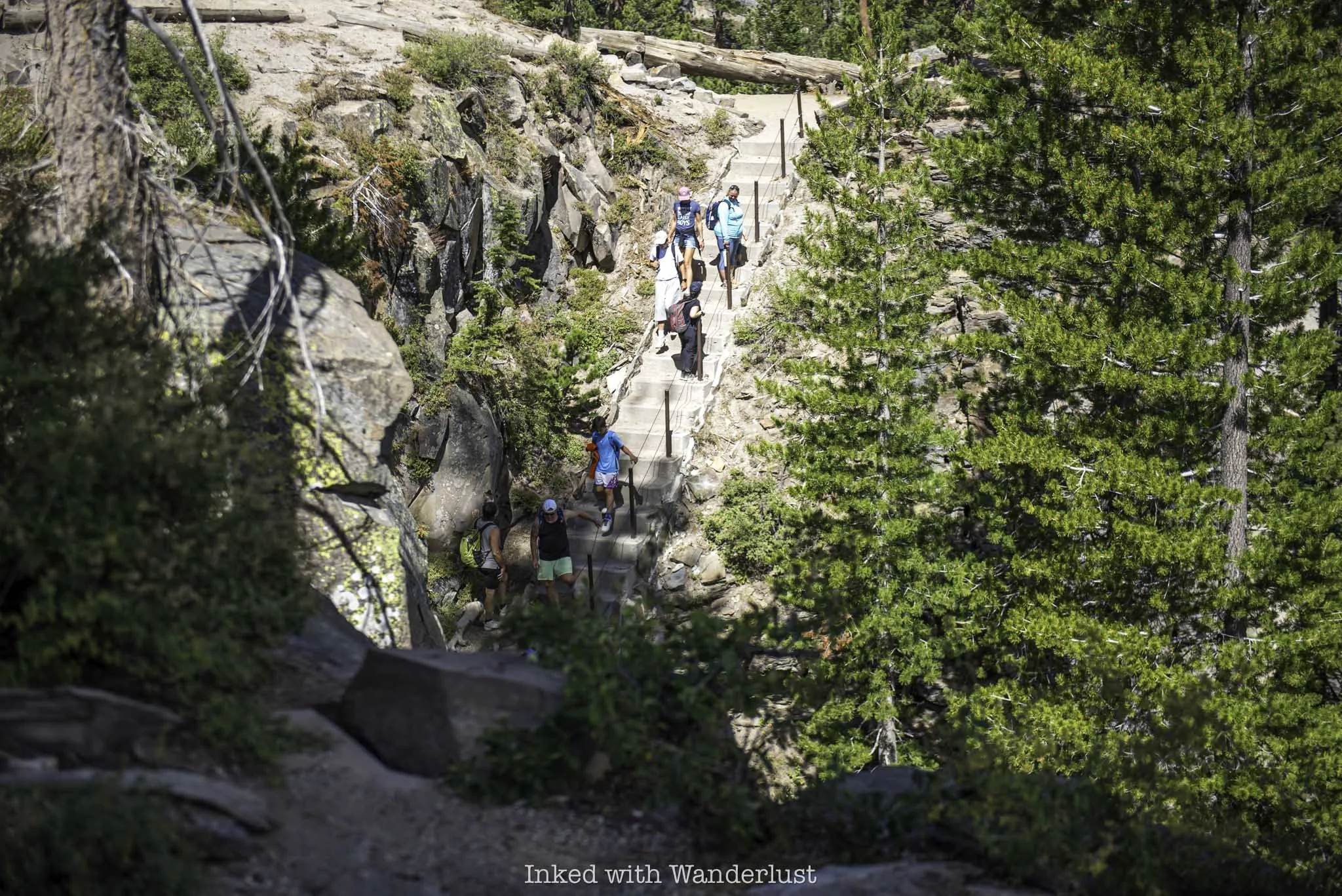 Hikers heading down the stairwell to the base of Rainbow Falls in California.