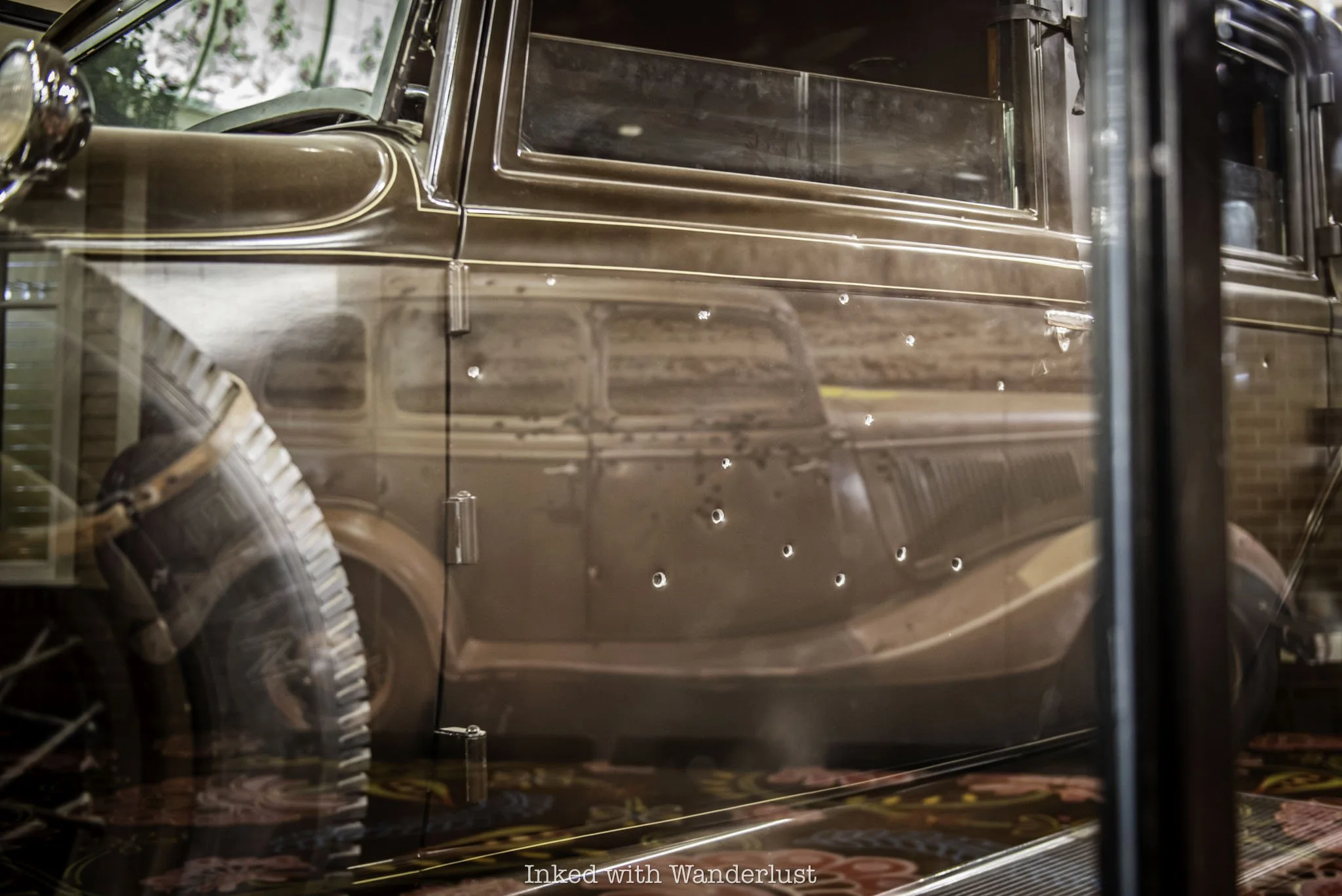 A reflection of the Bonnie and Clyde death car within Dutch Schultz car in Primm, Nevada.