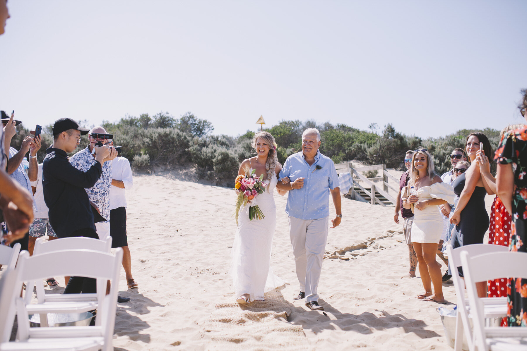 Geelong wedding bride walking down beach aisle 