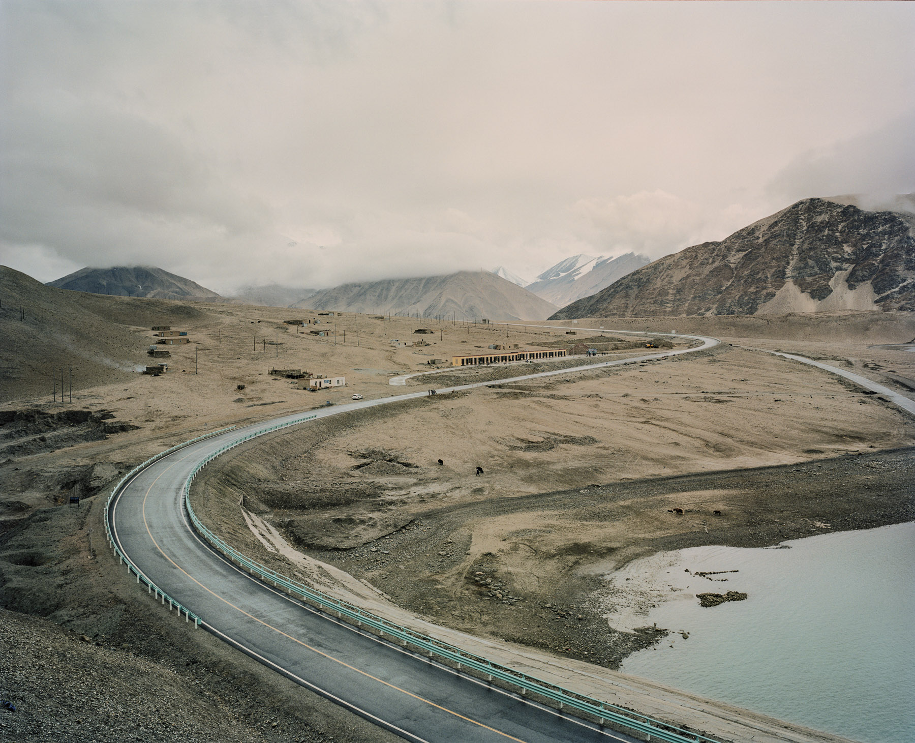 May 2016. Xinjiang province, China. View of road G314 in China, aka the Karakoram highway, the road linking the western Chinese province of Xinjiang with Pakistan through the Pamir mountains. On the right is the Baishahu lake.  