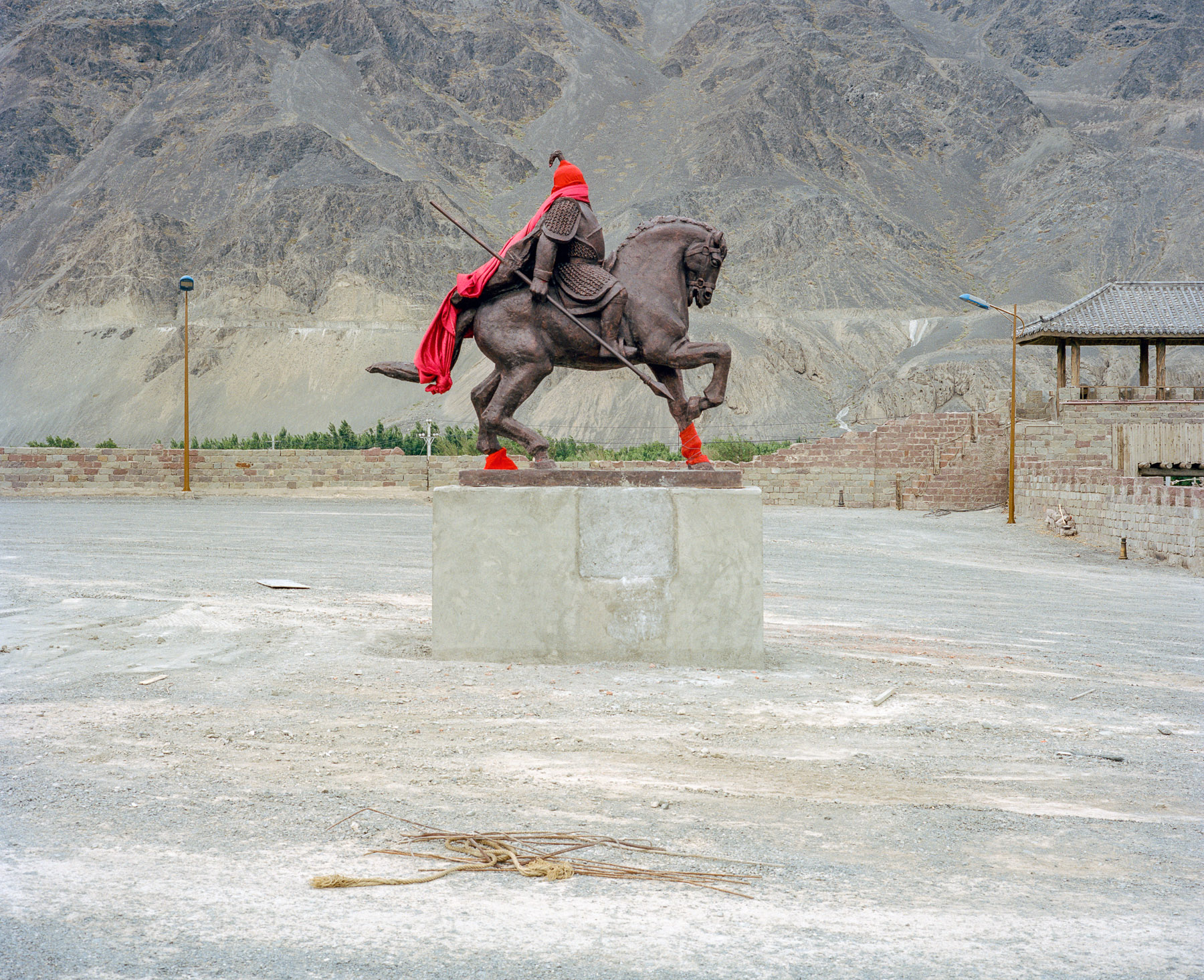  June 2016. Xinjiang province, China. On the road back from Turpan, a mostly Uighur oasis town, to Urumqi, Xinjiang's capital, we stop for a rest and see these two young Uighur men taking a nap under a bridge while the summer heat is reaching its pea