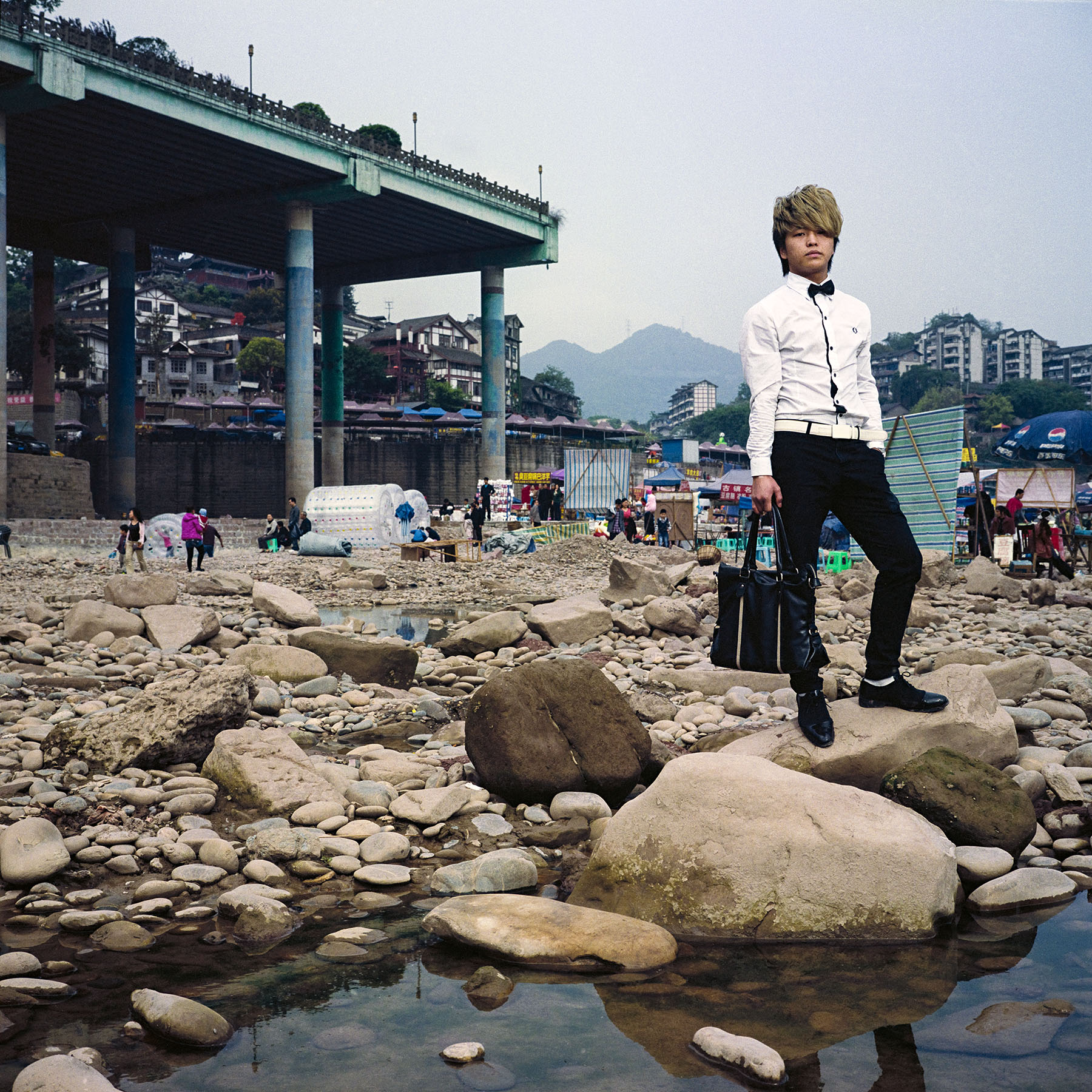  Chongqing, China. 2013. Chongqing is a major city in the Southwest of China and one of the five national central cities in the PRC. It is one of PRC's four direct-controlled municipalities and was created as such in 1997. It has a population of 28 m