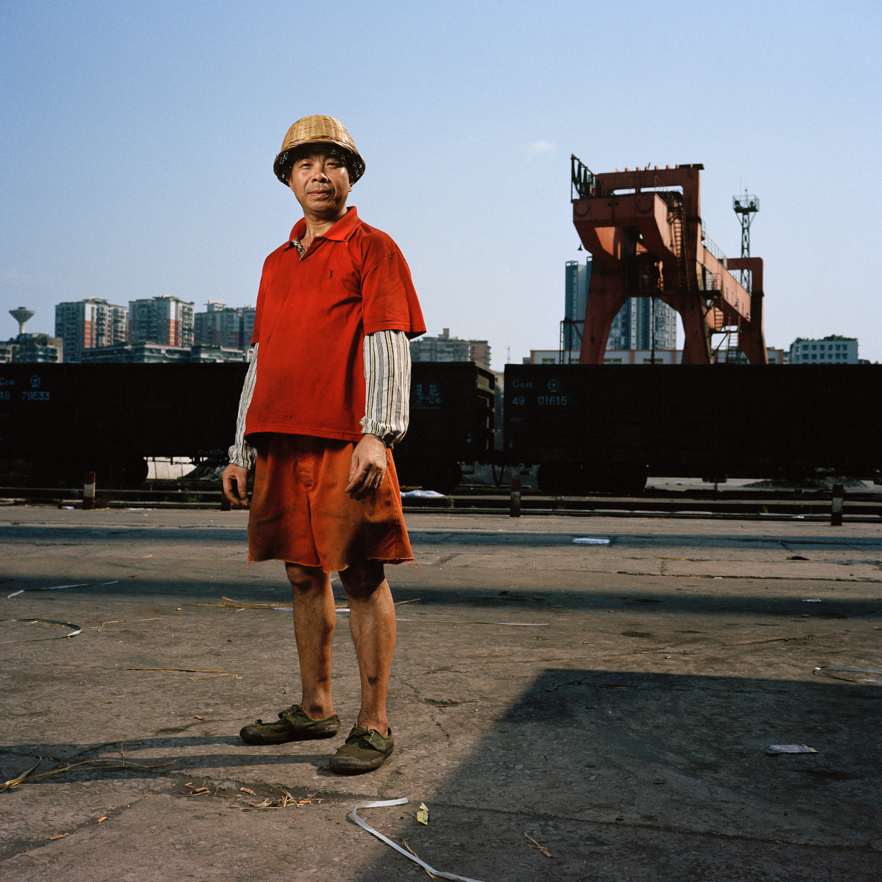  Chongqing, China. 2013. Docker Tian Yi Jun is posing for a portrait during his work shift at the Jiulongpo Port in Chongqing.
Chongqing is a major city in the Southwest of China and one of the five national central cities in the PRC. It is one of PR