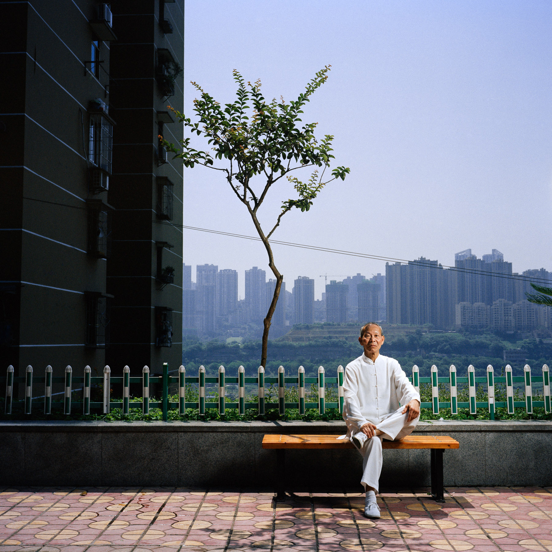  Chongqing, China. 2013. Old Chinese man Wang Wei posing in his traditional taichichuan outfit after his taichichuan session.
Chongqing is a major city in the Southwest of China and one of the five national central cities in the PRC. It is one of PRC