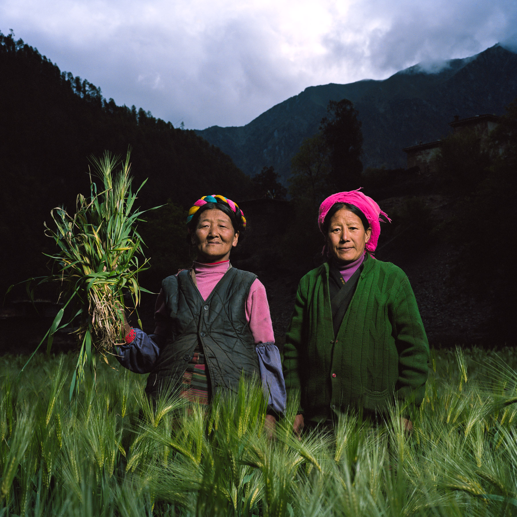  May 2012. Tibet province, China. Portrait of a Tibetan farmer woman and her sister near the village of Laide at 3100m high on the trail of the buddhist pilgrimage of the Kawa Karpo. 