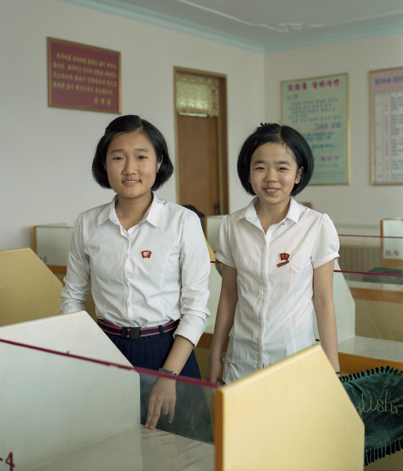  Highschool students posing for the camera in the city of Pyongsong. 