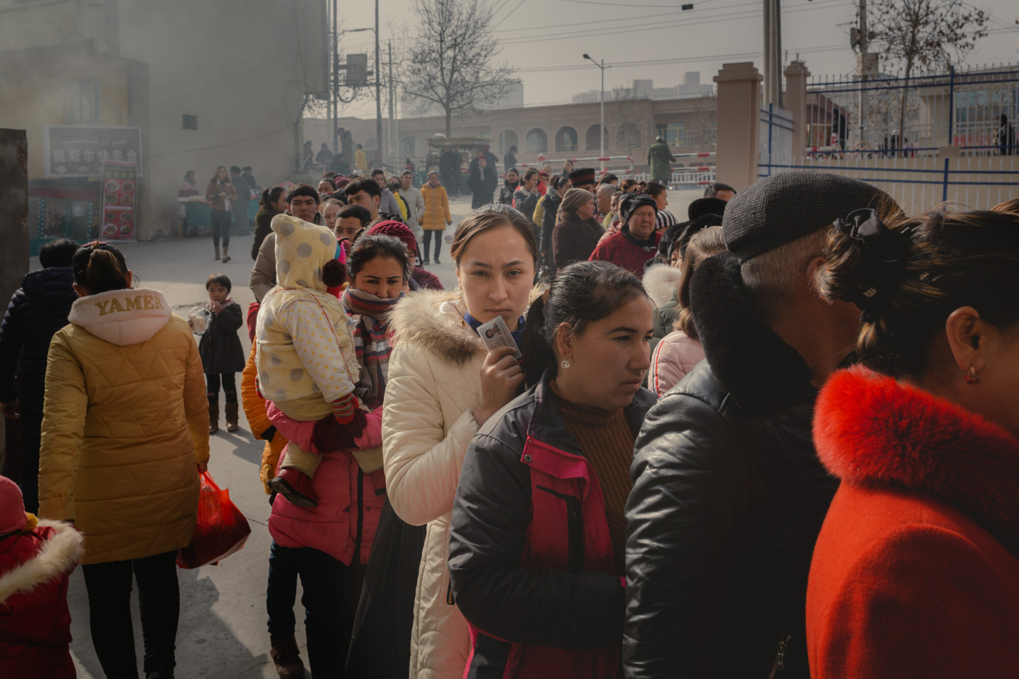  February 3rd 2019. Hotan, Xinjiang province. Uighur-minority locals wait in line for ID check and body searches before entering the local bazar. 