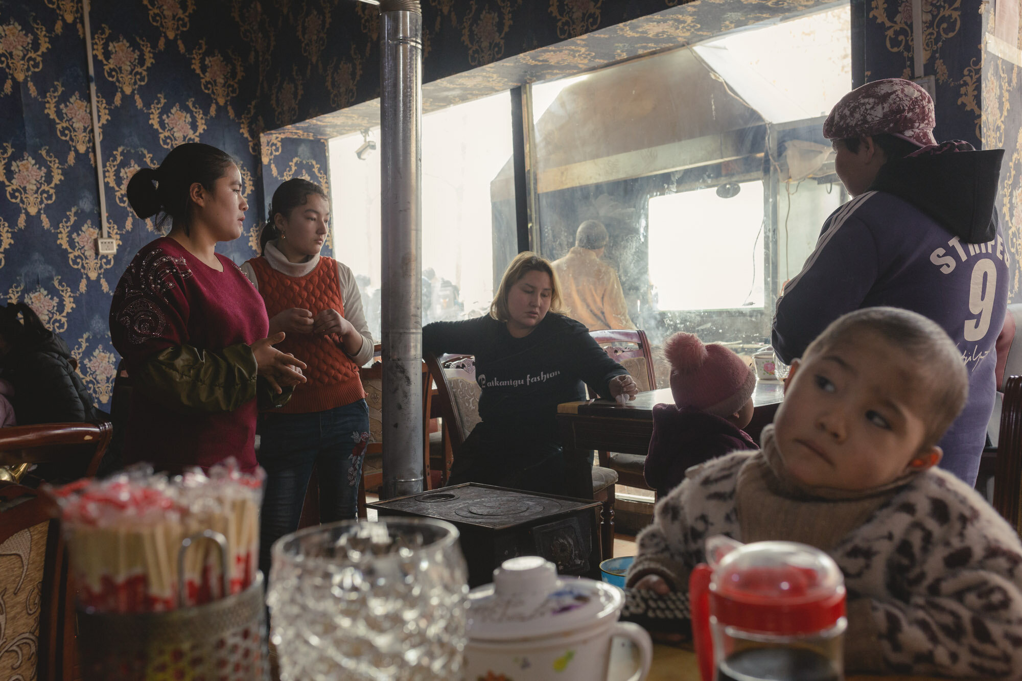  February 3rd 2019. Hotan, Xinjiang province. Uighur-minority restaurant staff and patrons with their children in a Uighur restaurant in the old twon of Hotan. 