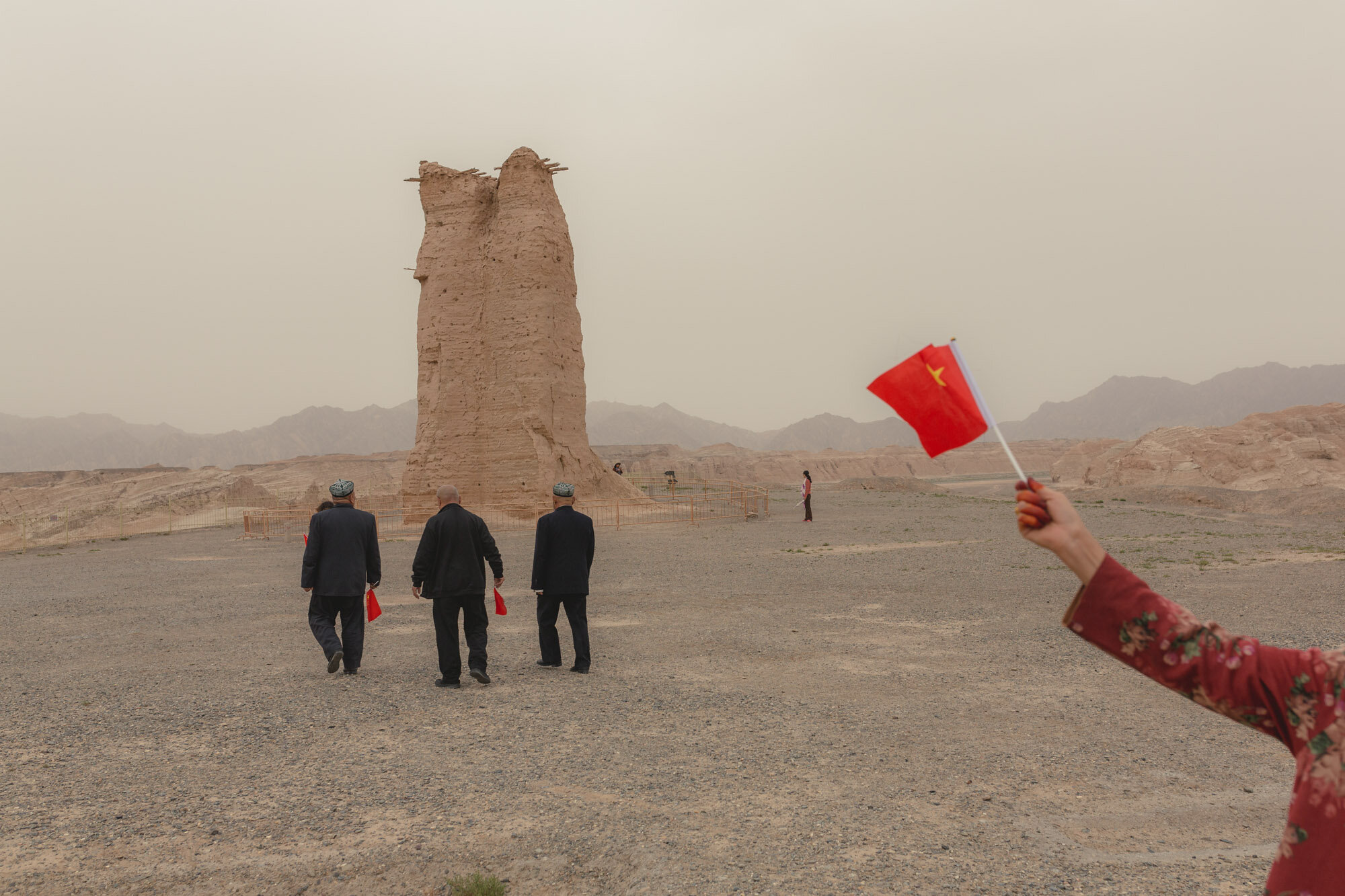  October 2nd 2019. Xinjiang province, China. A group of Uighur tourists on the site of the Kizil Gaha Beacon Tower (克孜尔尕哈烽燧 Kèzīěr gǎhā fēngsuì). Located 10km southeast of Kuqa, this was the site of a military facility built during the Han Dynasty. 
