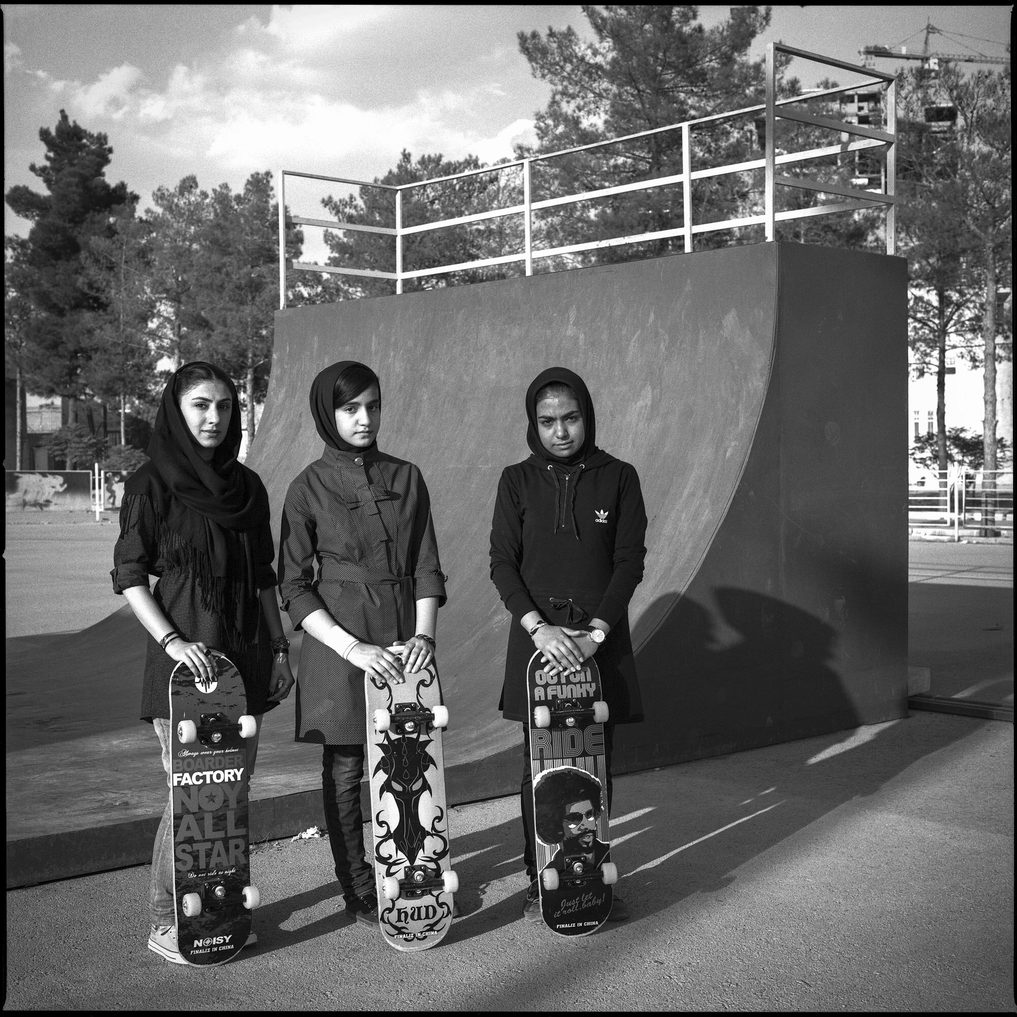  Three skater girls wearing mandatory veils and long sleeves in front of a half-pipe in Kerman, Iran, on October 4, 2015. 