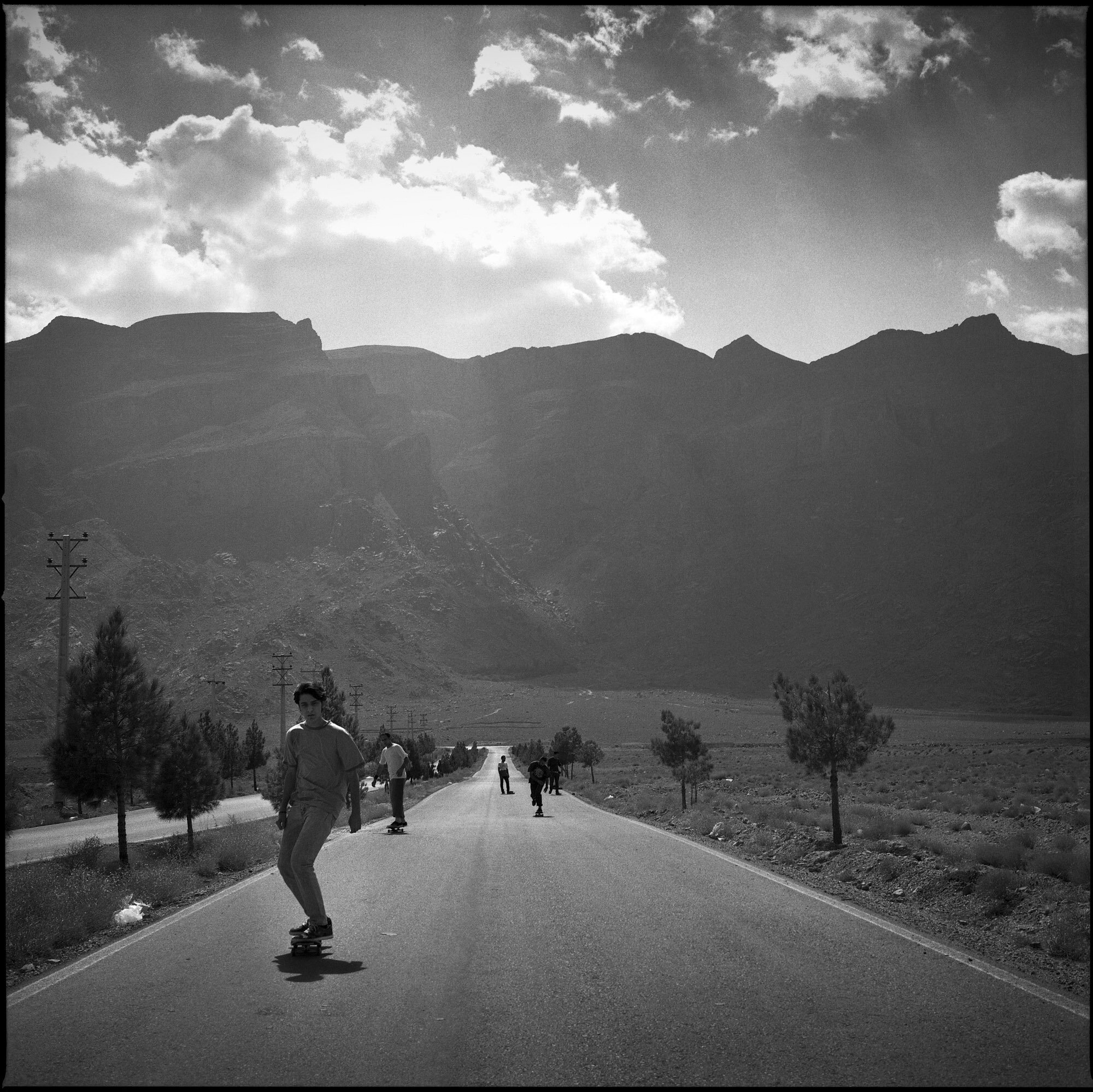  A group of skateboarders from Tehran stop near Yazd to ride on roads through the Iranian mountain landscape. Yazd, Iran, October 1, 2015. 