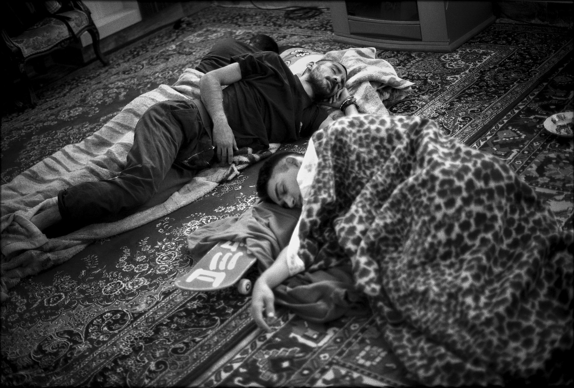  Erfan and Arian sleep on Persian rugs. Arian uses a skateboard as a pillow. Isfahan, Iran, September 28, 2015. 