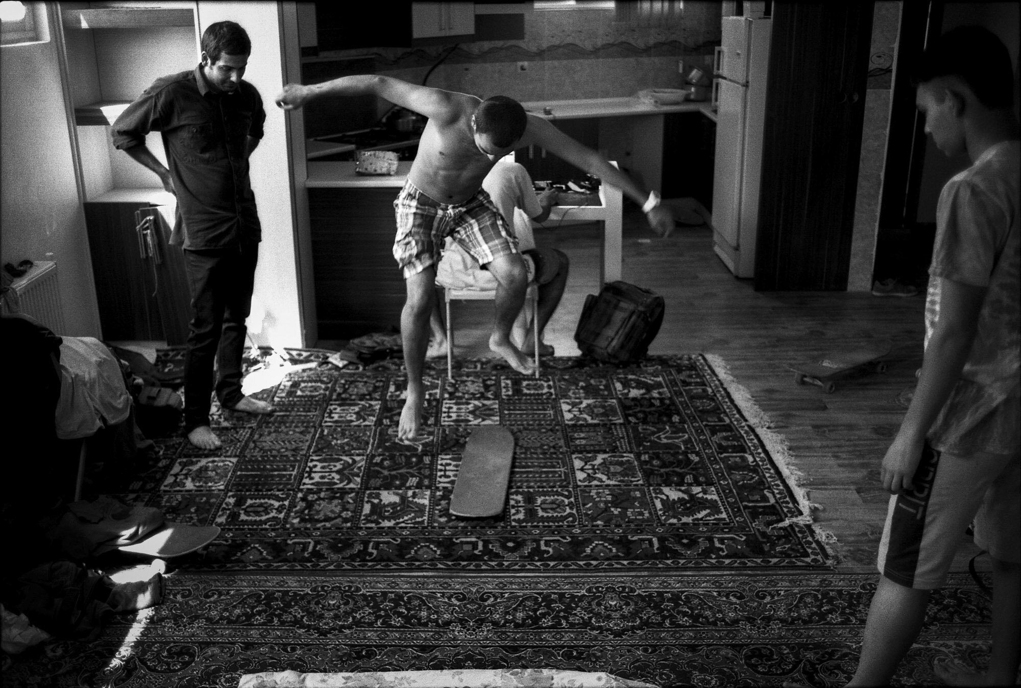  Nima, Mohamad and Arian play with a skateboard without wheels on a persian rug in an apartment in Isfahan, Iran, on September 29, 2015. 
