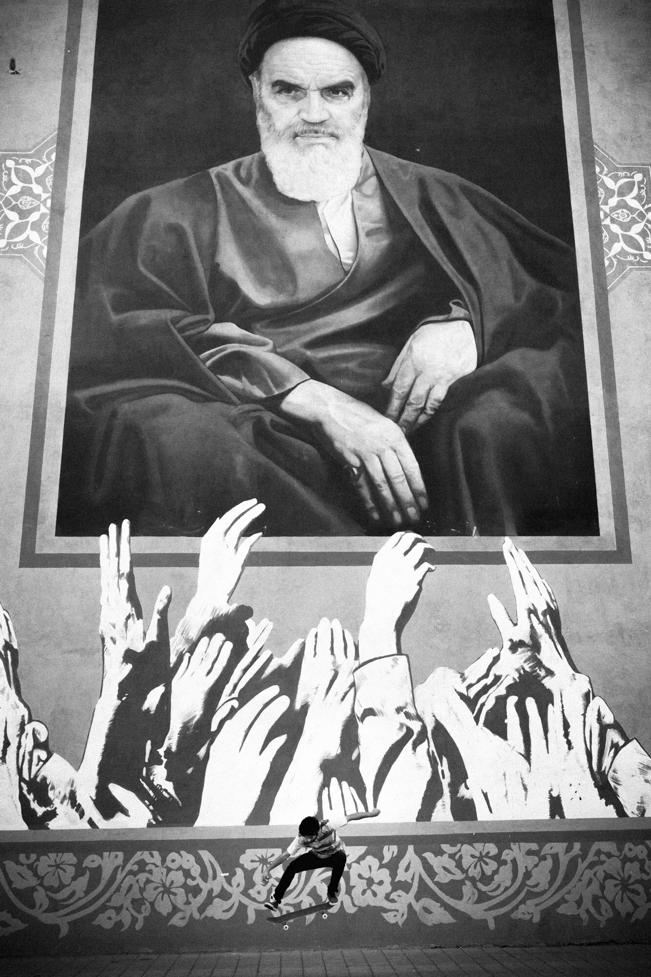  In south of Tehran, Ashkan performs a skate trick in front of a gigantic mural representing the ayatollah Khomeini, the Supreme Leader of the Islamic Revolution. Tehran, Iran, October 24, 2015. 