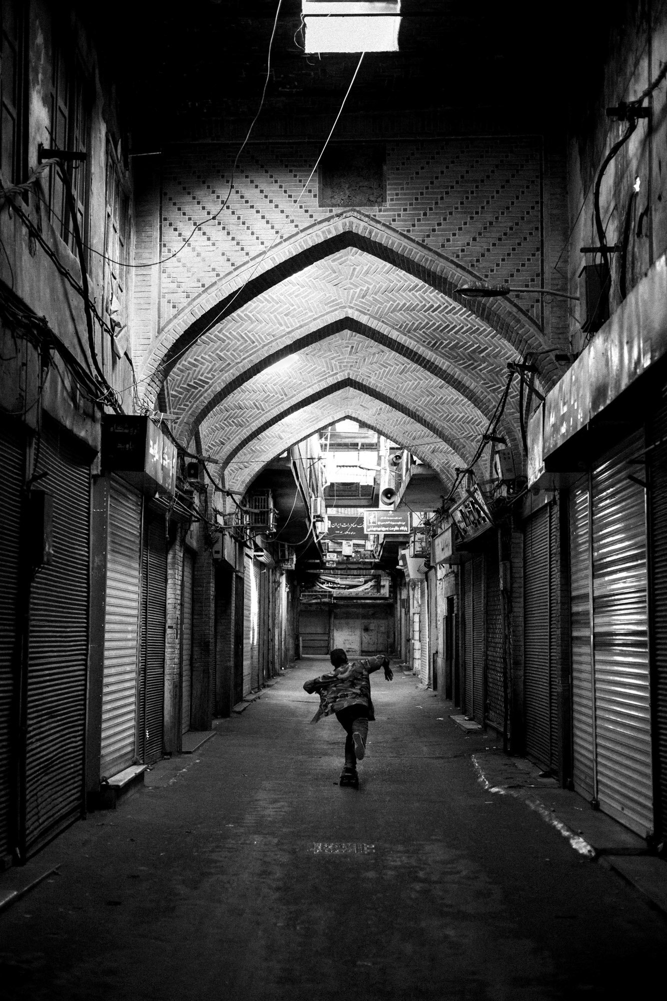  Erfan skates in the Grand Bazaar which is empty on Fridays. Tehran, Iran, September 24, 2015. 