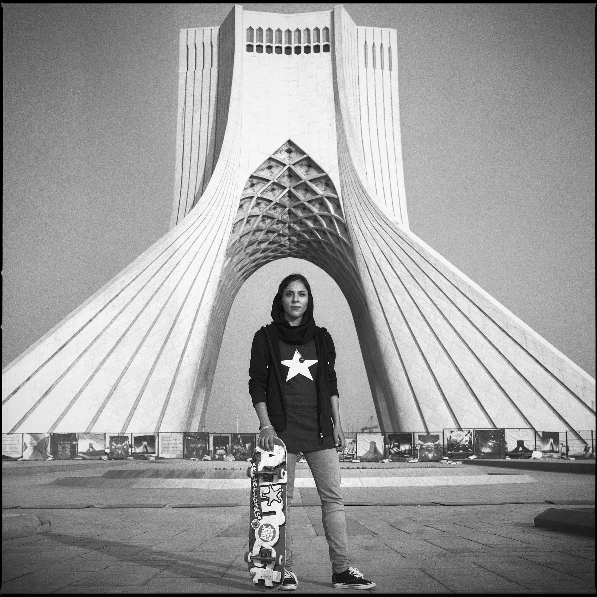  Elham, 24 years old, skater girl from Tehran in front of the Azadi tower. Tehran, Iran, October 25, 2015. 