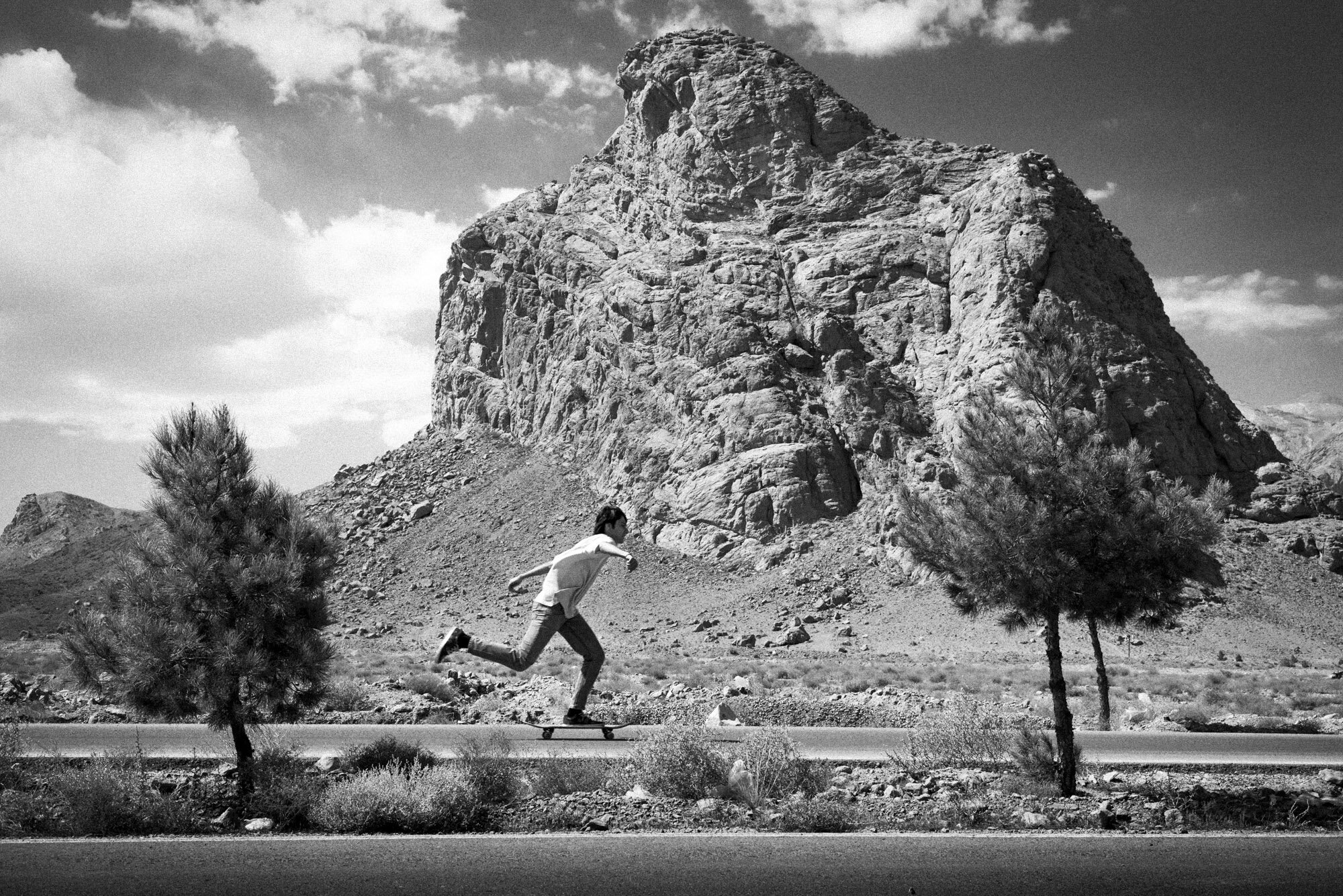  Mehrad, 18 years old, skateboards in front of the Eagle Mountain near Yazd, Iran, on October 1, 2015. 