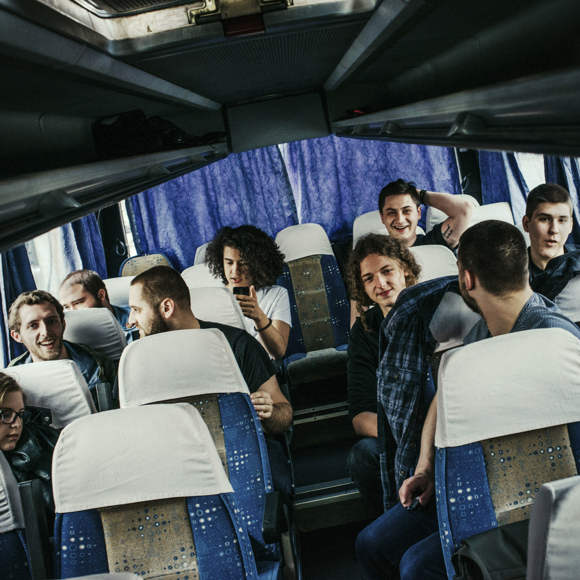  Students of Mitrovica Rock School sit and discuss together in the bus. The bus drives Albanian and Serb students from Mitrovica to the Serb enclave of Gracanica where they will perform a concert. Mitrovica, Kosovo, March 25, 2017. 