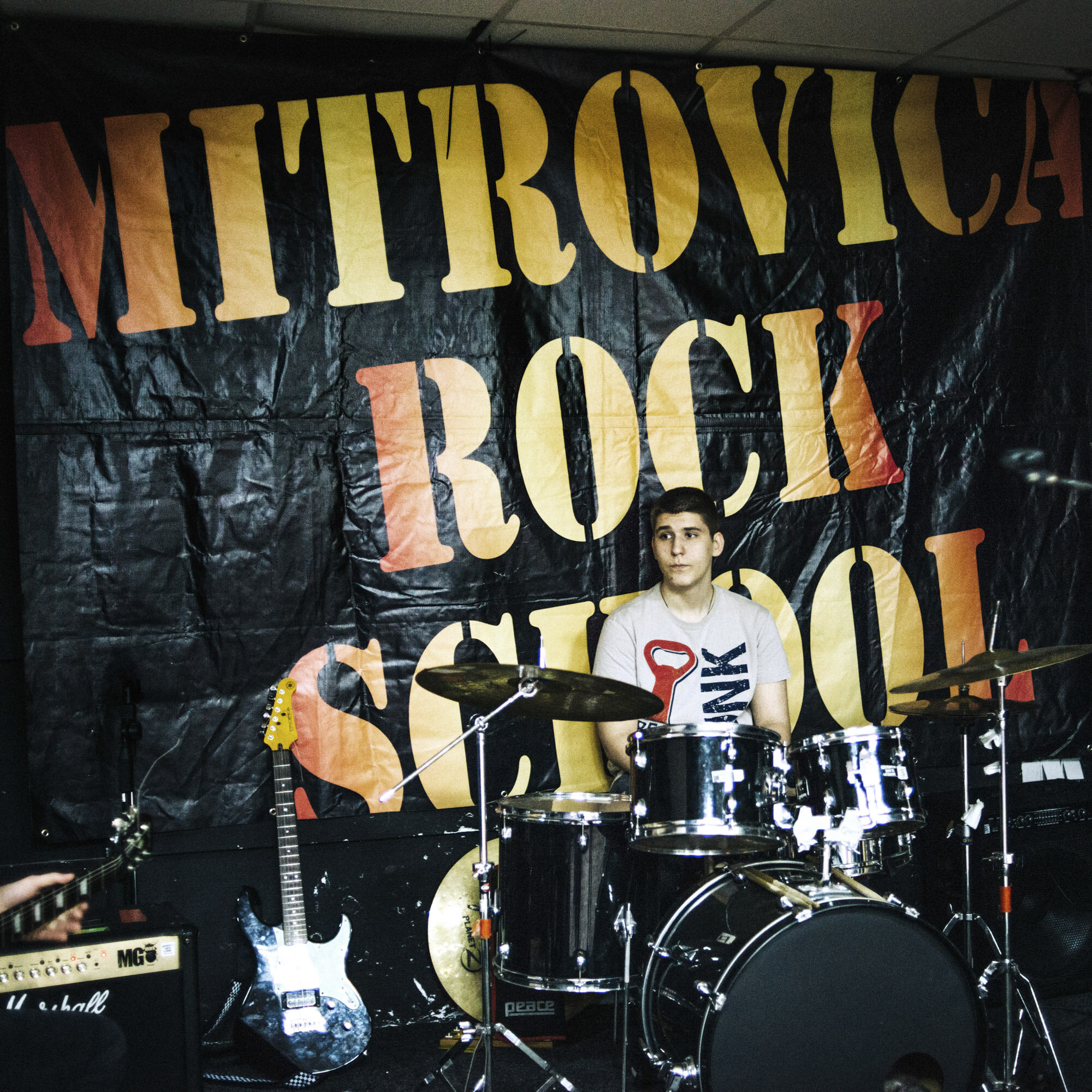  Baton Haxhikadriu plays drum during a rehearsal with his multiethnic rock band in the south branch of the Mitrovica Rock School. Mitrovica, Kosovo, March 24, 2017. 