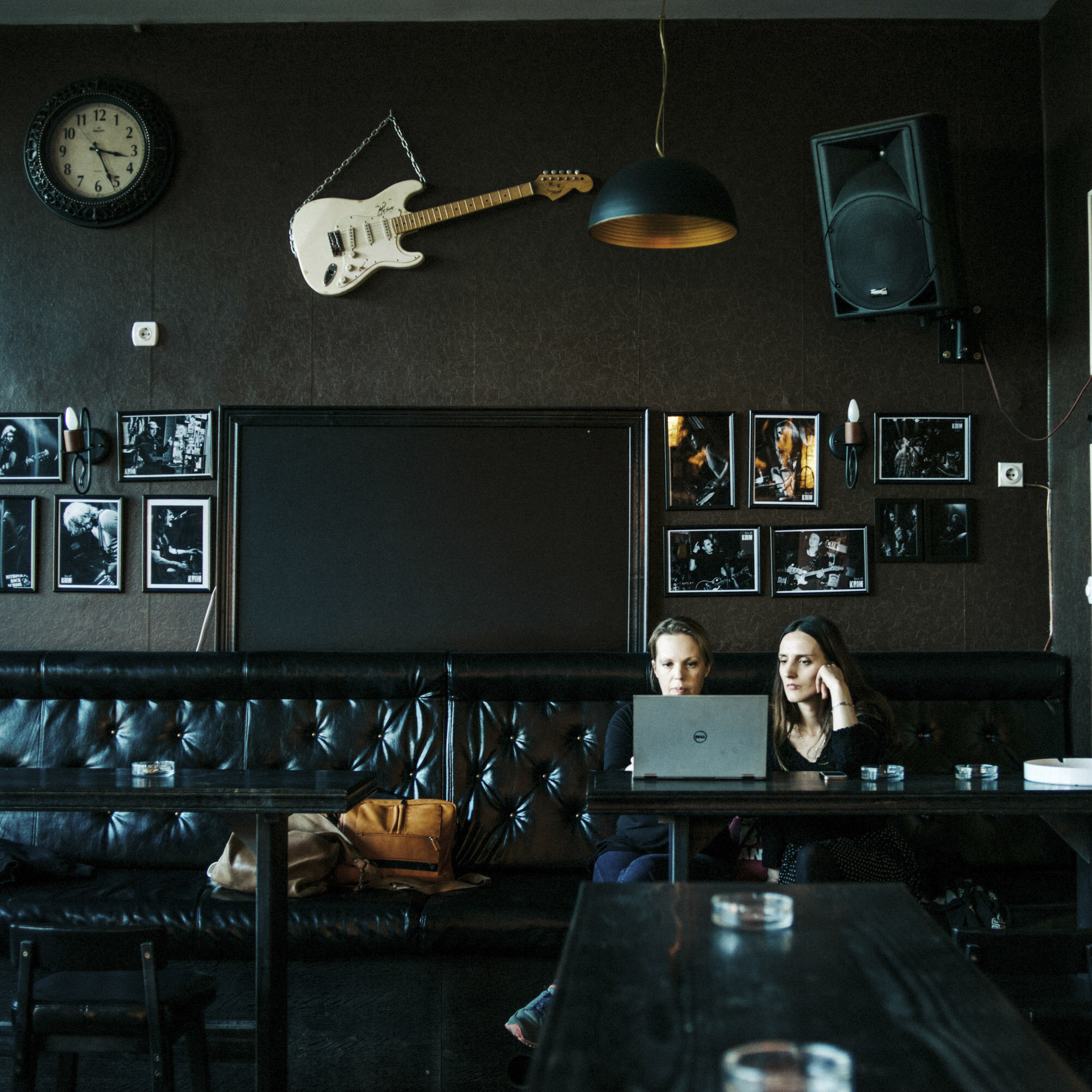  Wendy Hassler-Forest (on the left), rock school director, in the facilities of the northern branch of the rock school. On the wall, a guitar and pictures of rock musicians who came by in Mitrovica to play. Mitrovica, Kosovo, March 24, 2017. 