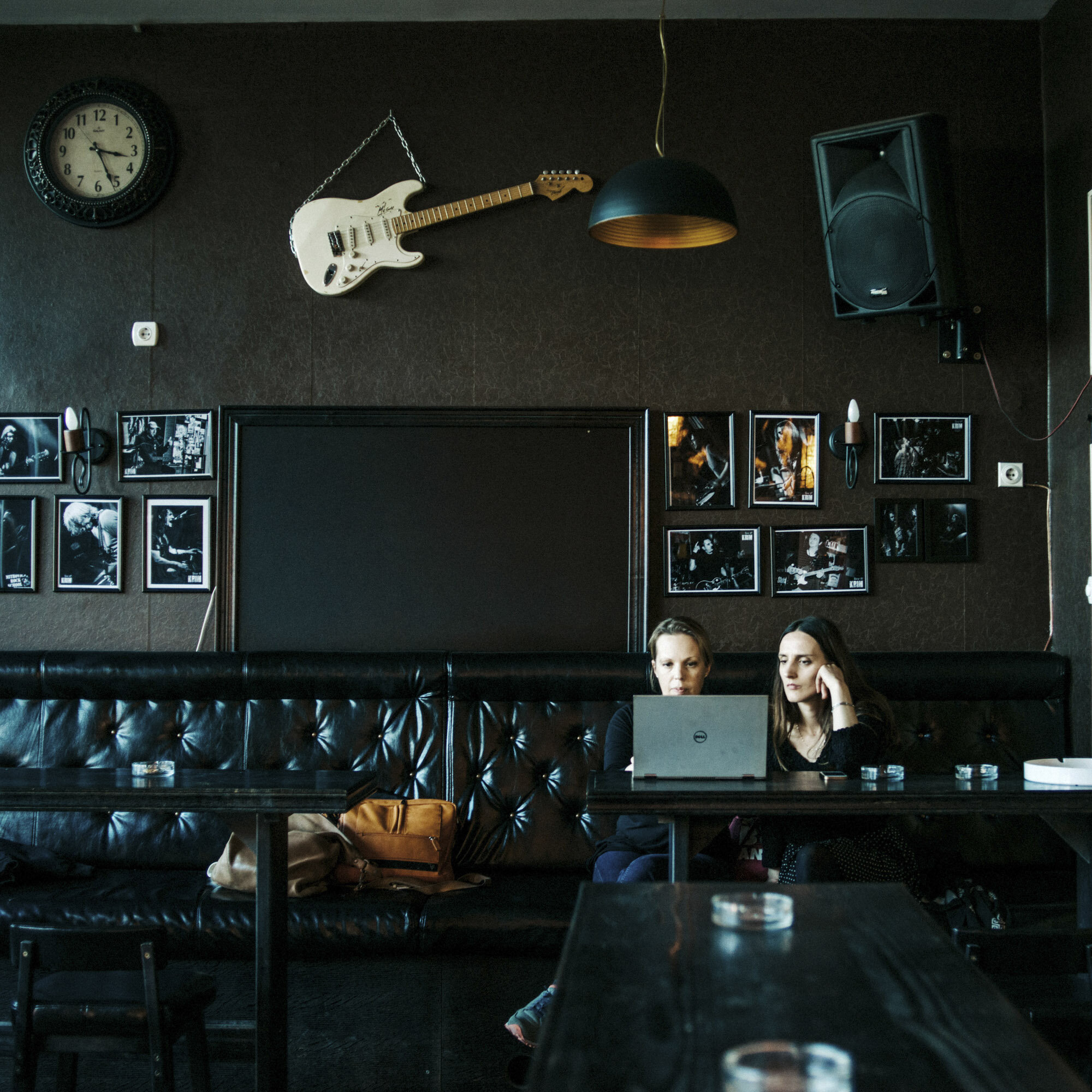 Wendy Hassler-Forest (on the left), rock school director, in the facilities of the northern branch of the rock school. On the wall, a guitar and pictures of rock musicians who came by in Mitrovica to play. Mitrovica, Kosovo, March 24, 2017.