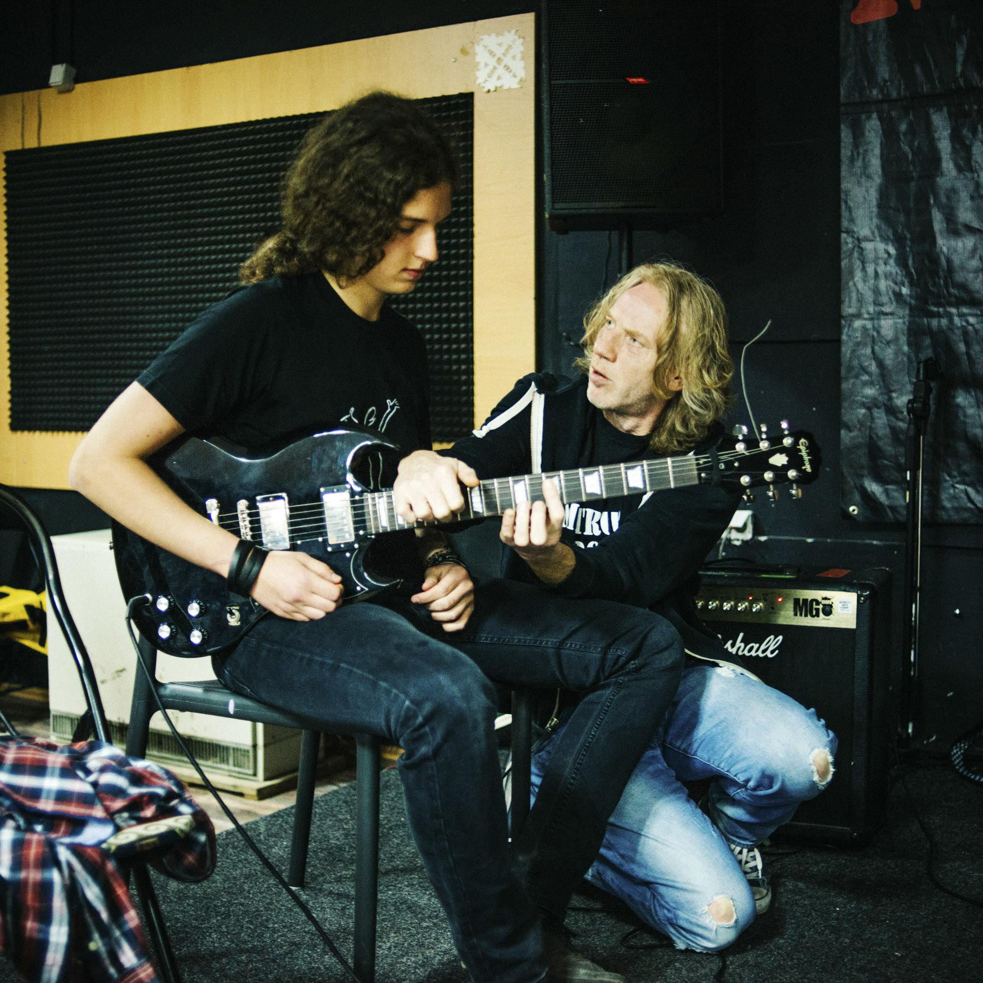  In the southern branch of Mitrovica Rock School, Ruud Borgers, a regular external teacher, coaches a student who plays guitar. He travelled from the Netherlands to coach young people during the rehearsal week of multi-ethnic bands. Mitrovica, Kosovo