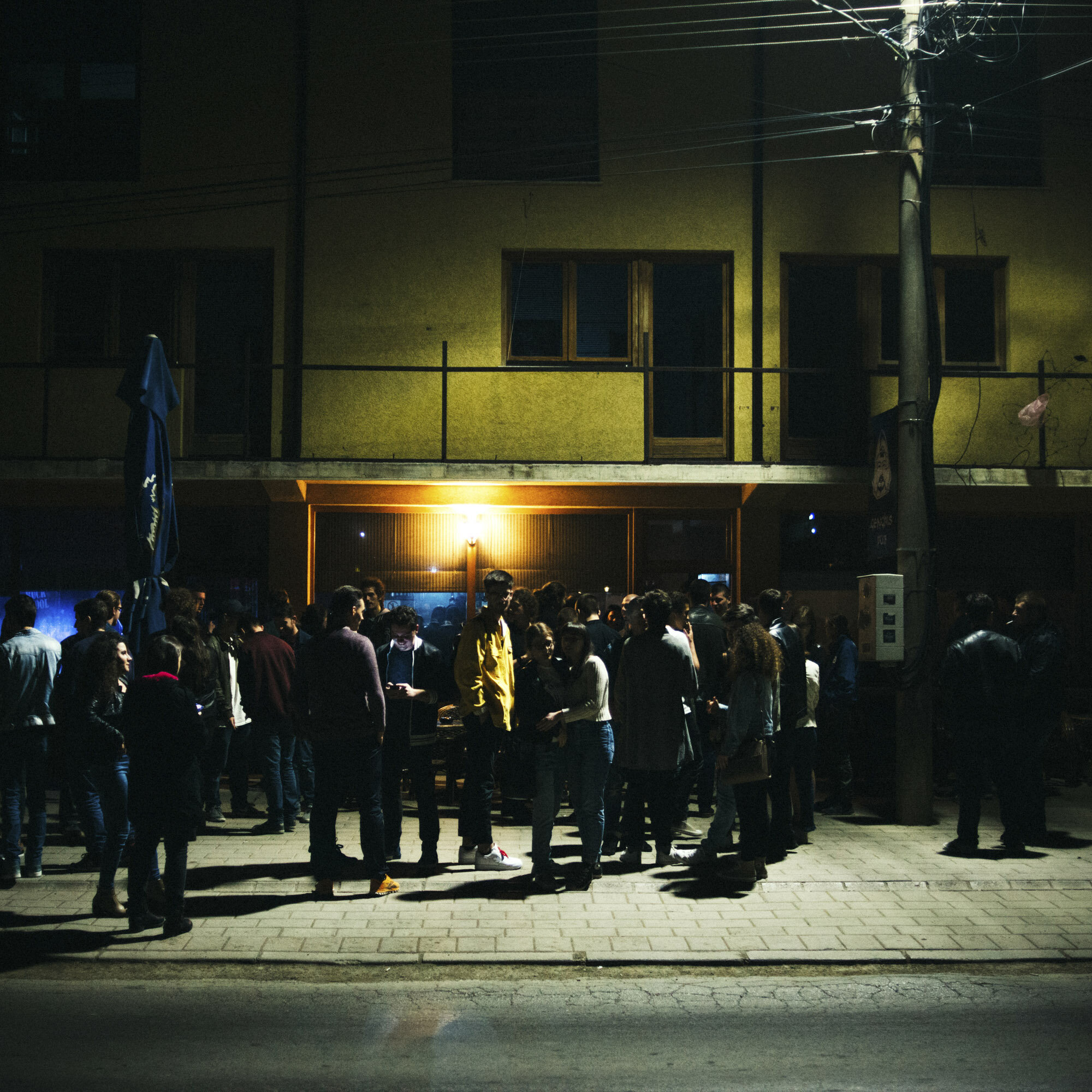  Albanian and Serbian young people in front of the Genchis Pub during the Mitrovica Rock School concert. The pub is located in the Serbian enclave of Gracanica. Gracanica, Kosovo, March 25, 2017. 