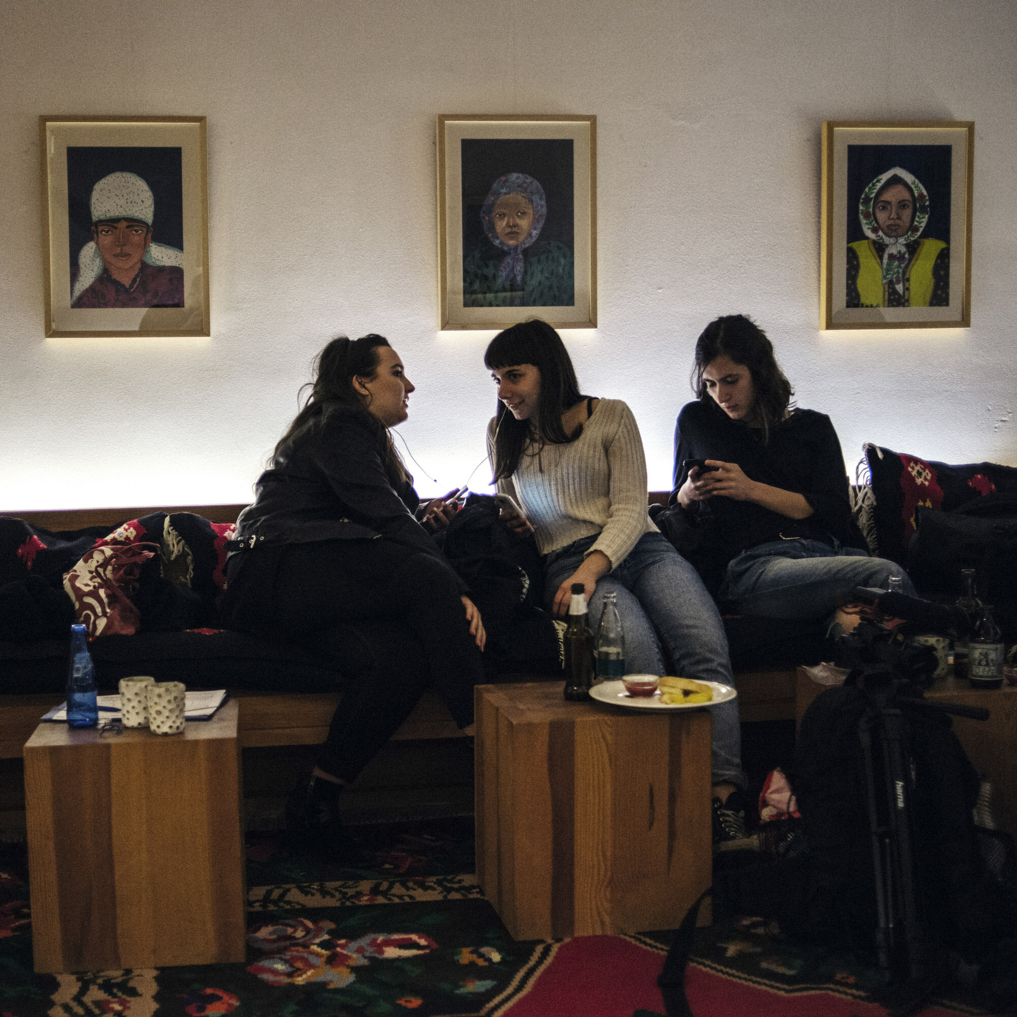 Dua and Ilda listen to music and sing as Tringa writes messages on her phone. Before their concert at the Genchis Pub in Gracanica, the students from the rock school went to dinner and drink some beers at the Hotel Gracanica. Gracanica, Kosovo, Marc
