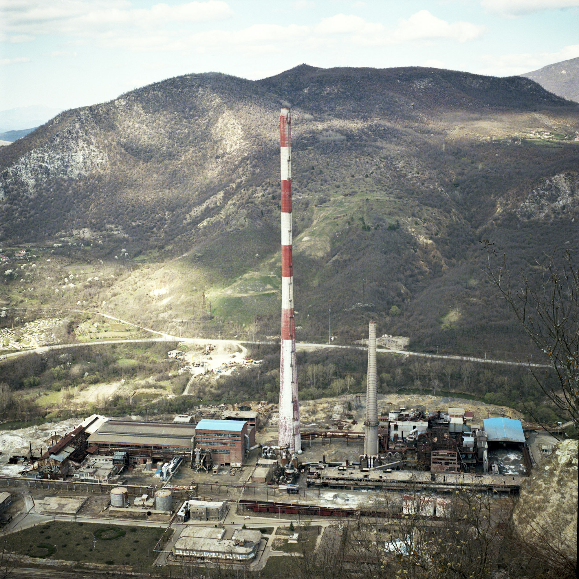  An abandoned factory in front of a mountainous landscape in northern Mitrovica which is the Serbian part of the city. Mitrovica, Kosovo, March 27, 2017. 