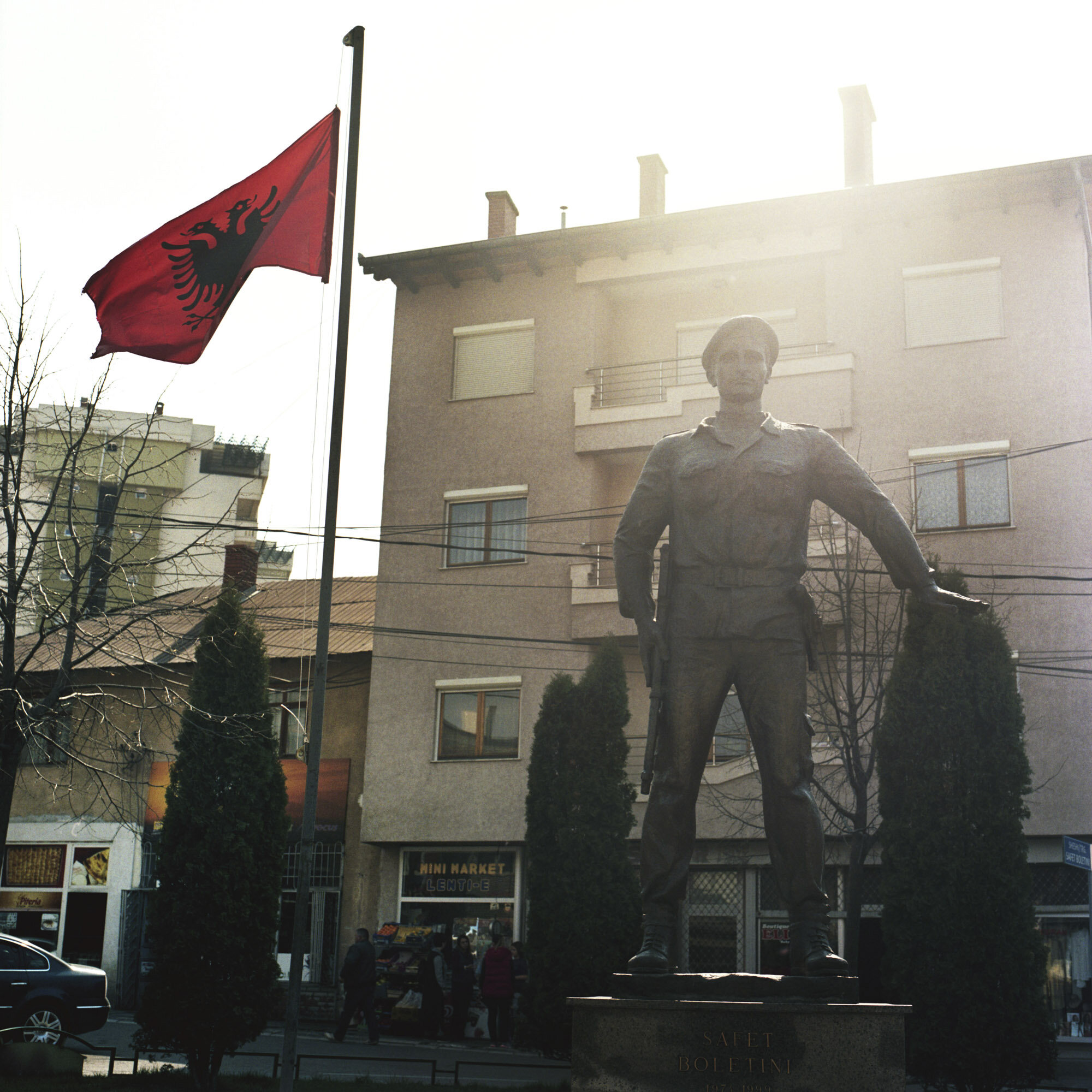 An Albanian flag and a statue representing Safet Boletini, an Albanian war hero. Mitrovica, Kosovo, March 25, 2017.