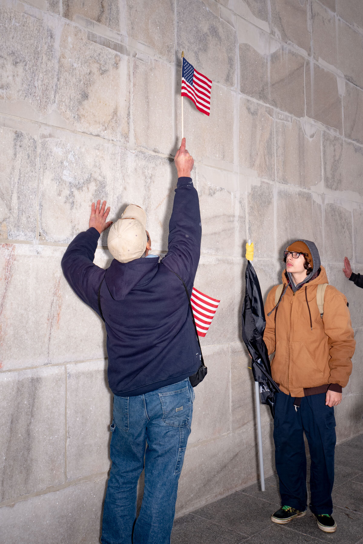  January 6th 2021 - Two trump supporters are touching the Washington Monument during the last Trump rally leading to the Storming of the Capitol in Washington. 