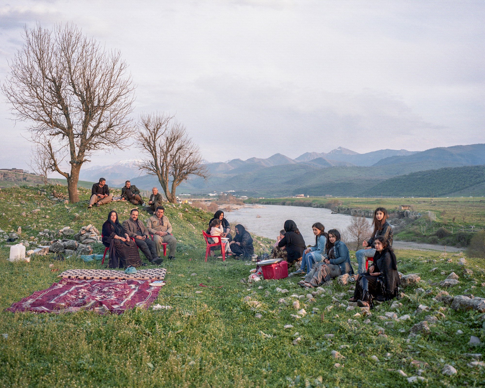  Kurdish family having a picknick with Greater Zab River on the background during Newroz (Kurdish newyear) Barzan, Iraq. 